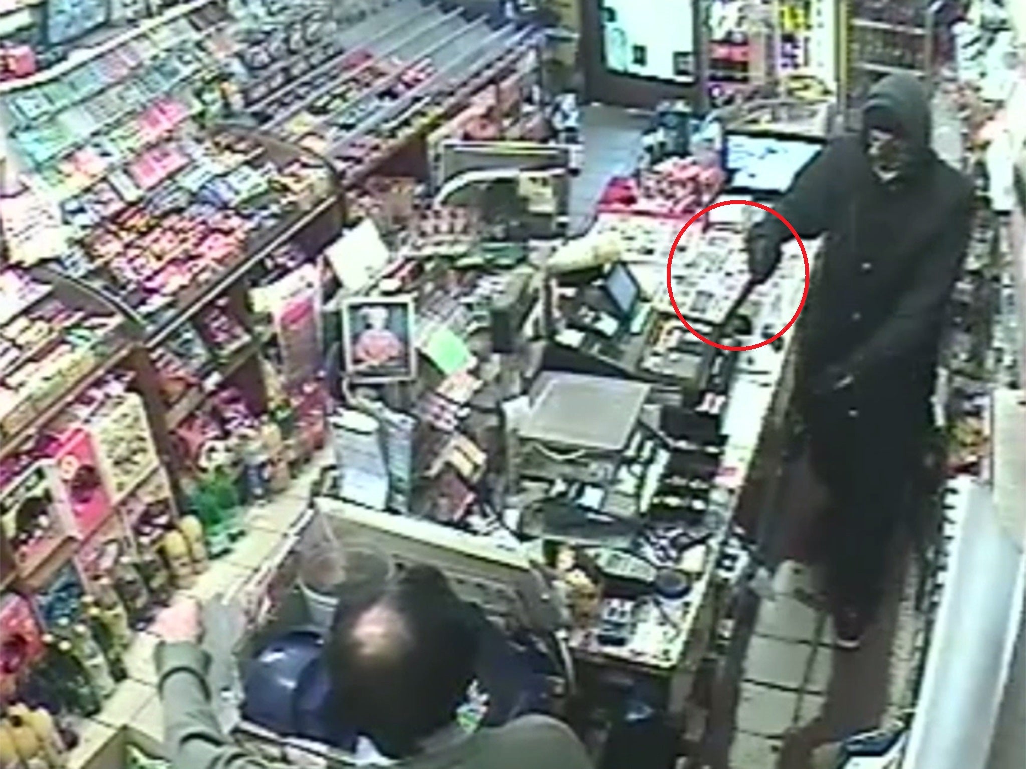 The moment the newsagent owner is threatened with the knife