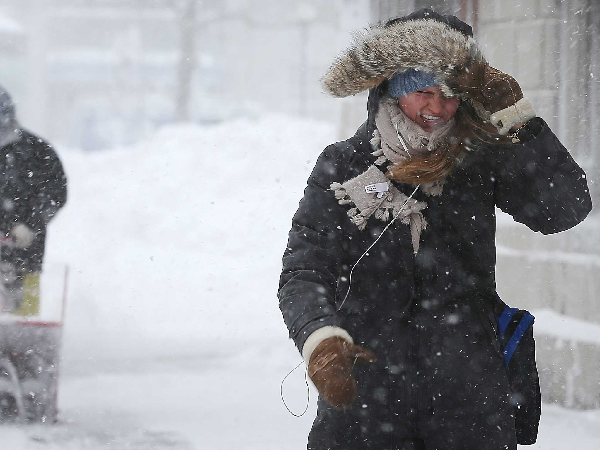 An American woman battles through a snow storm in 2013