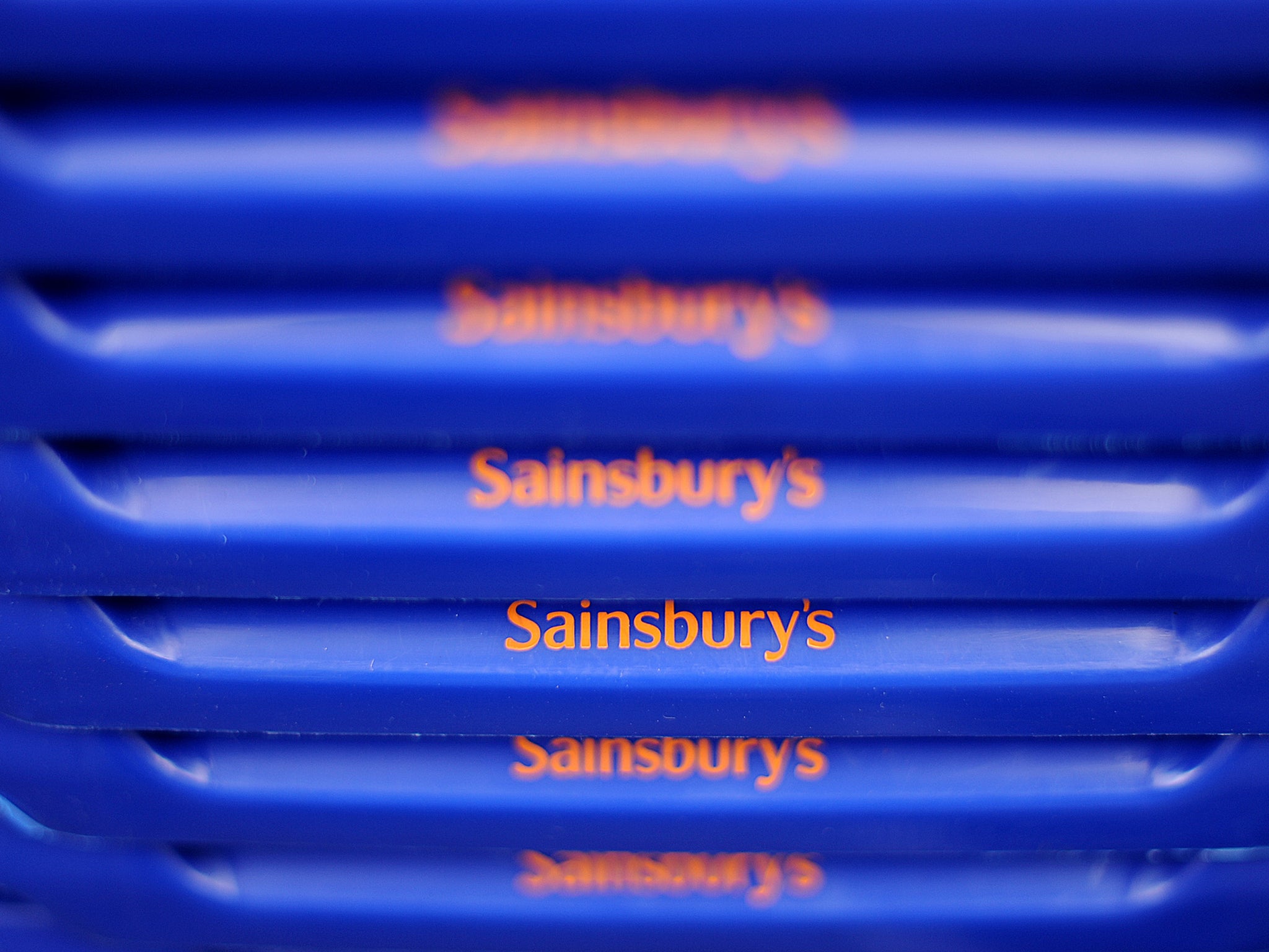 Shopping baskets featuring the Sainsbury's supermarket logo are pictured in London.