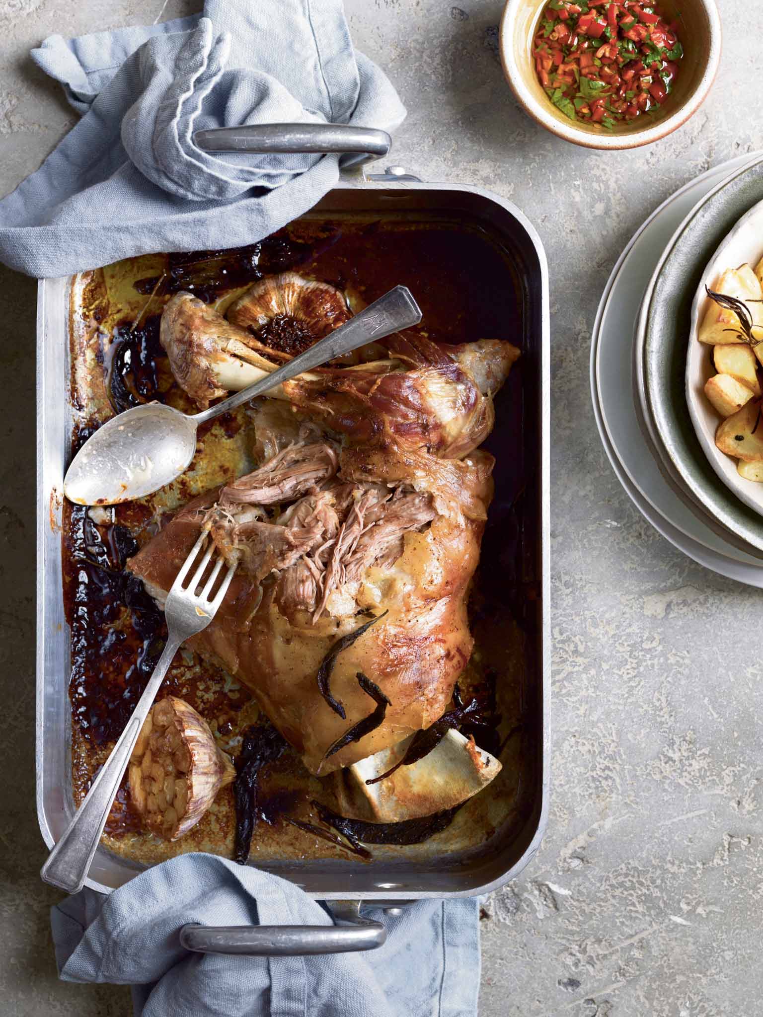 Slow-roasted lamb shoulder with rosemary potatoes and chilli relish
