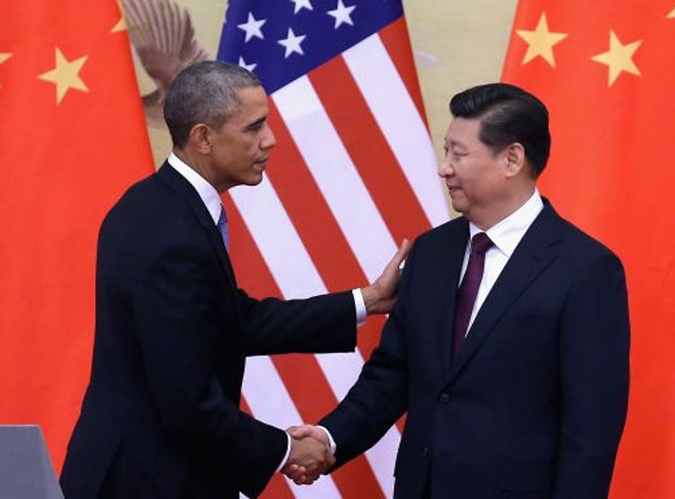 US President Barack Obama shakes hands with Chinese President Xi Jinping 