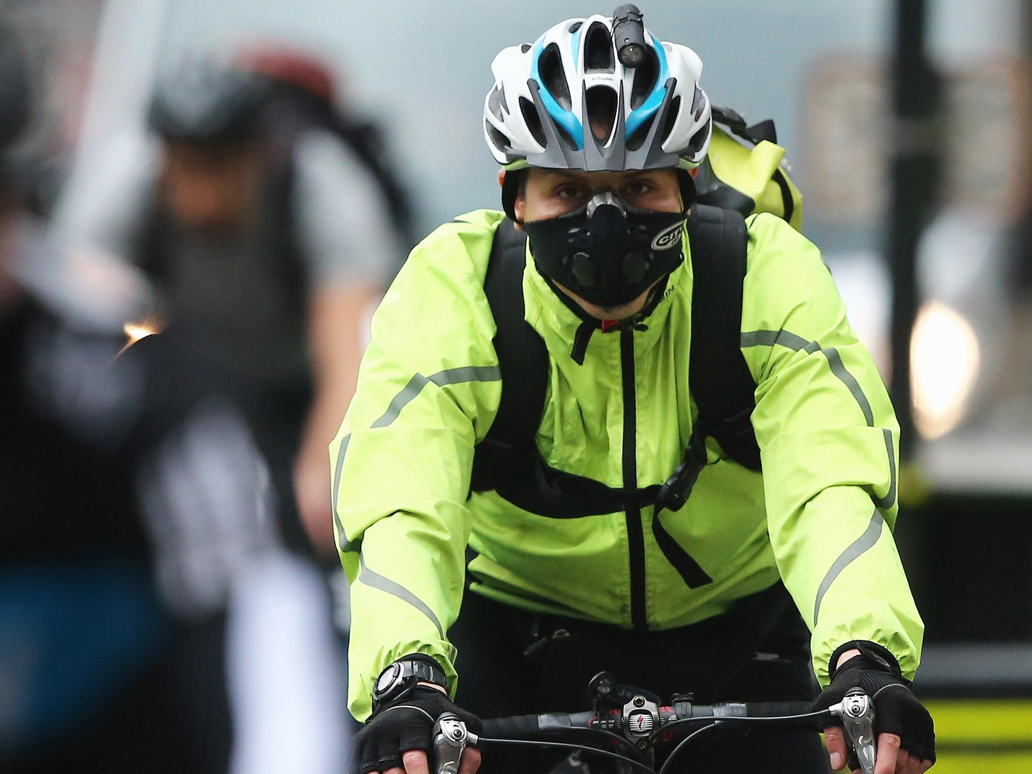 A London cyclist wears a face mask to avoid inhaling pollution