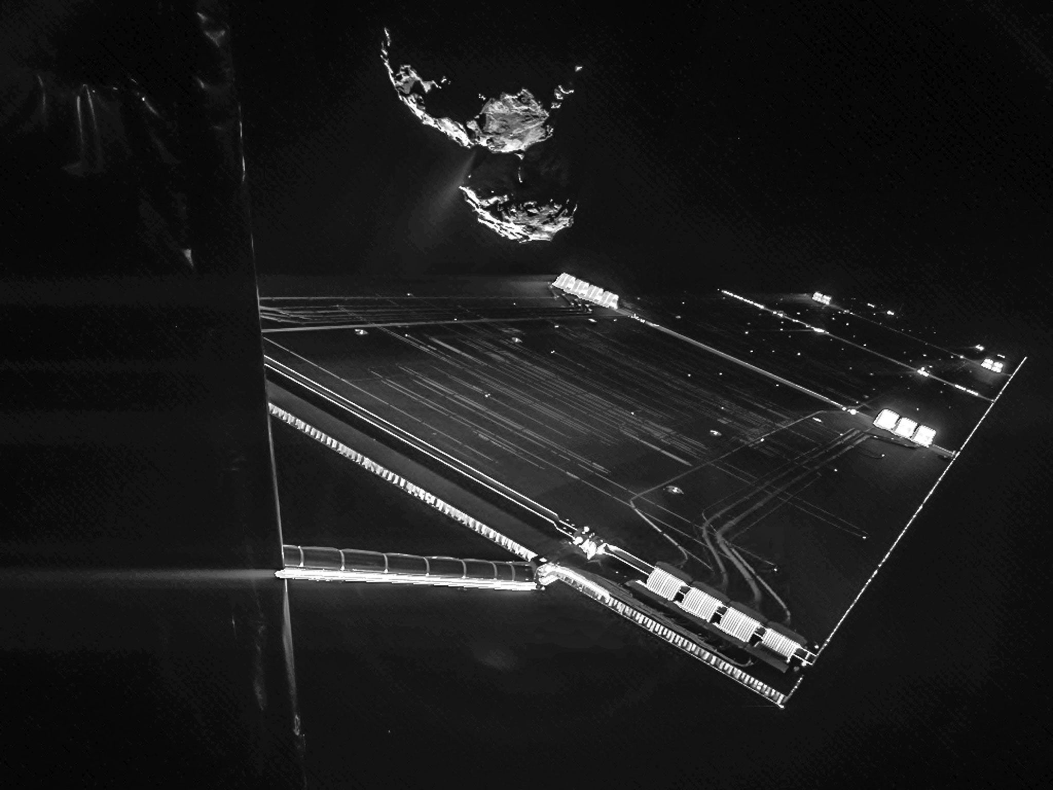 Image taken on 7 October 2014 by the CIVA camera on Rosetta's Philae lander from a distance of about 16 km from the surface of the comet. It captures the side of the Rosetta spacecraft and one of Rosetta's 14 m-long solar wings, with the comet in the back