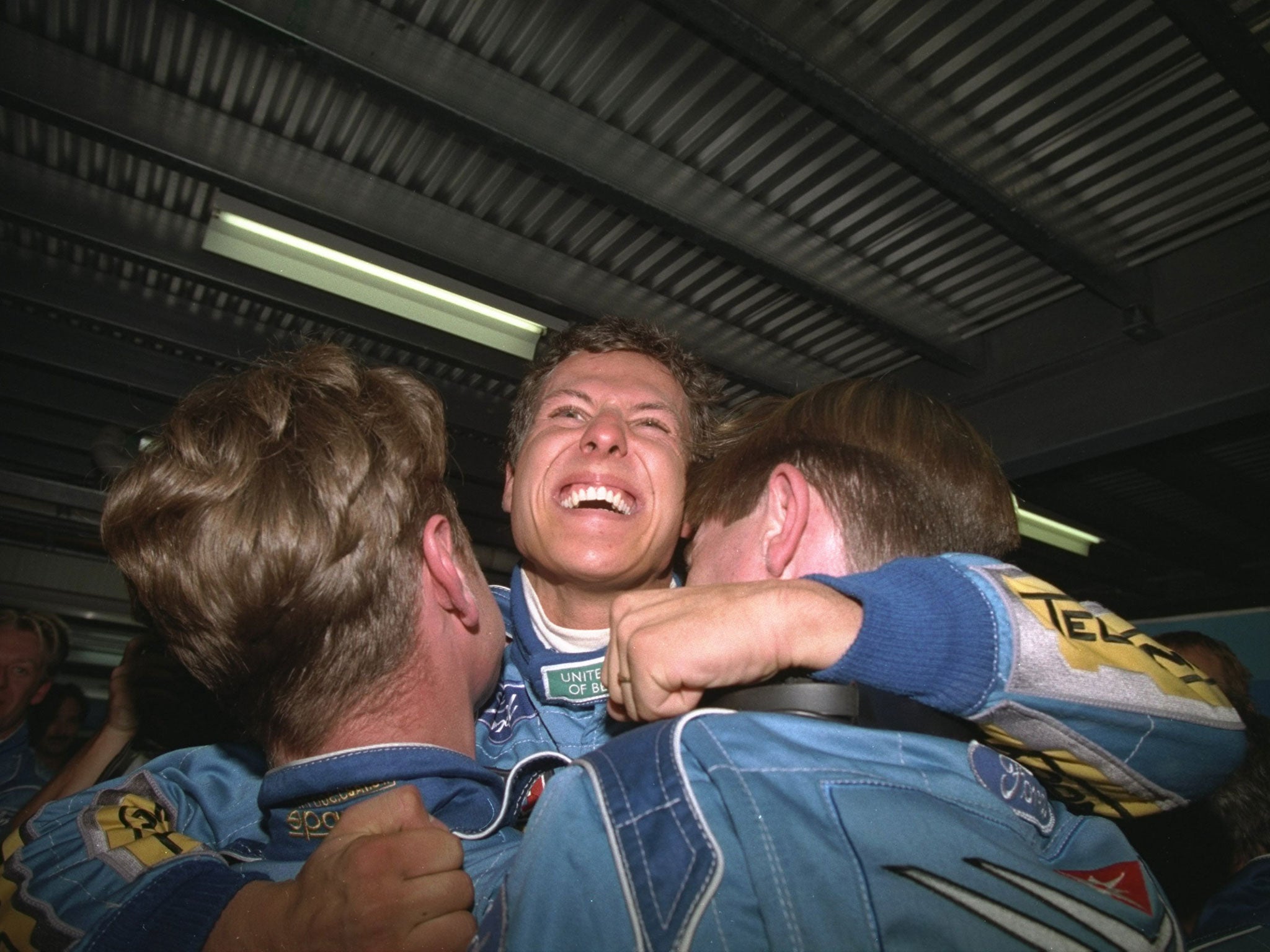 Schumacher celebrates with his mechanics after winning the 1994 world championship