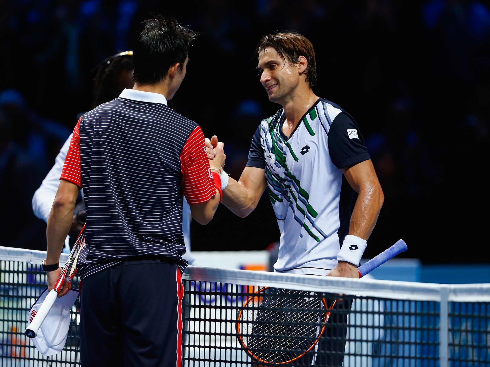 Kei Nishikori of Japan is congratulated on winning the round robin singles match by David Ferrer
