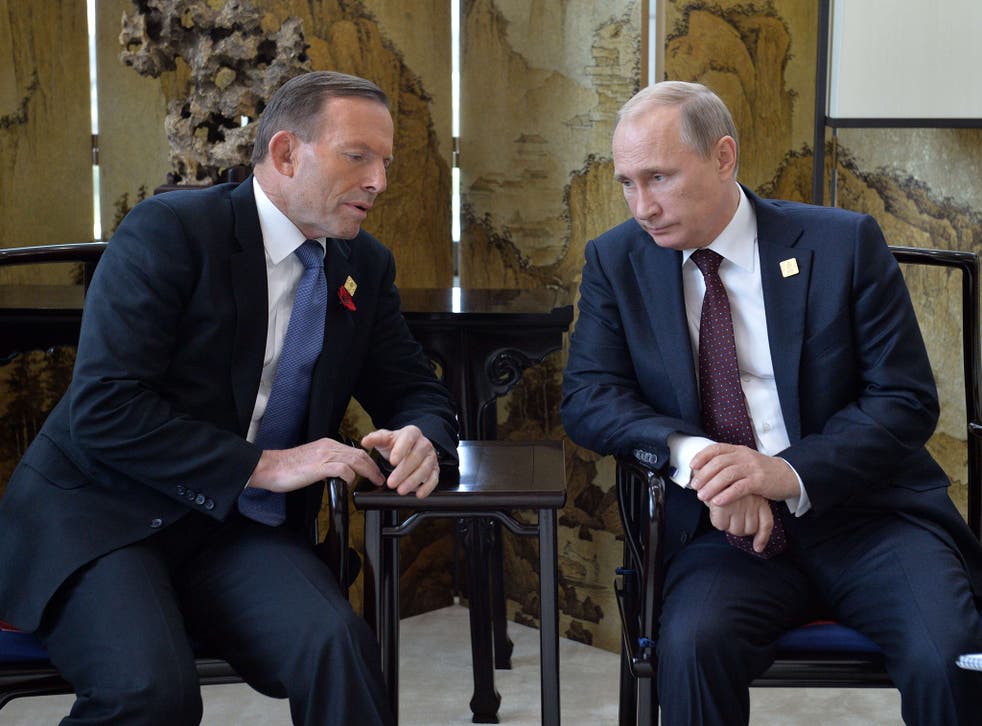 Russian President Vladimir Putin (R) speaks with Australia's Prime Minister Tony Abbott before the Asia-Pacific Economic Cooperation (APEC) Summit earlier this week