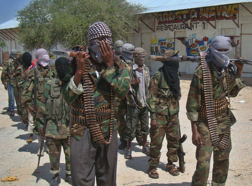 Al-Qaeda linked al-shabab recruits walk down a street in the Somalian capital, Mogadishu