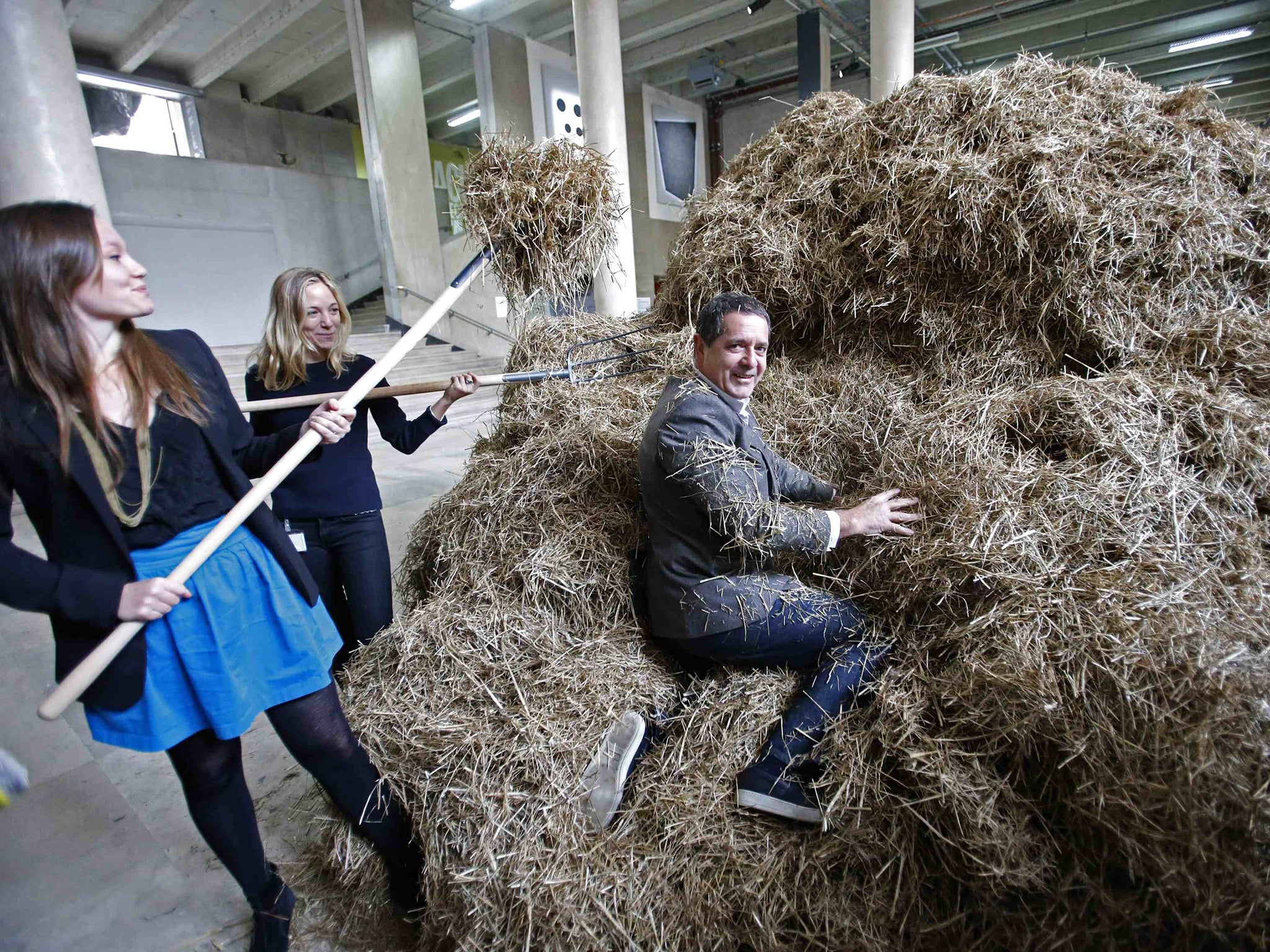 Italian artist Sven Sachsalber sifts through a haystack
