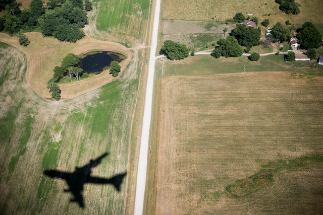 The shadow of an airplane is seen over fields in Missouri.