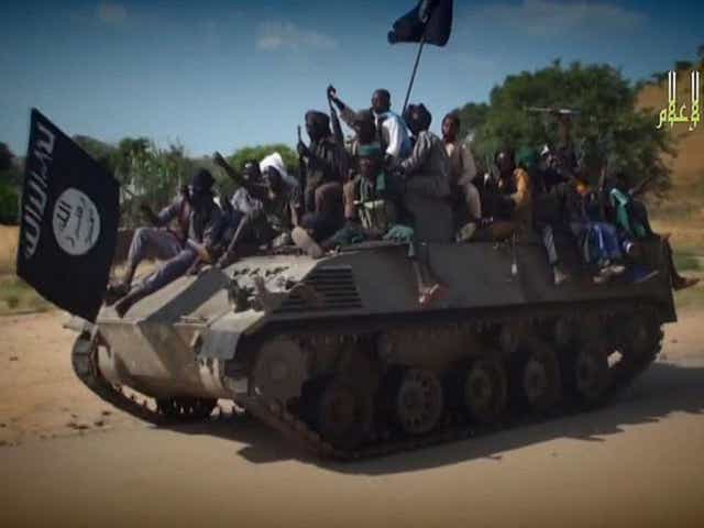 Boko Haram militants ride on a tank: the group has just captured the town of Chibok