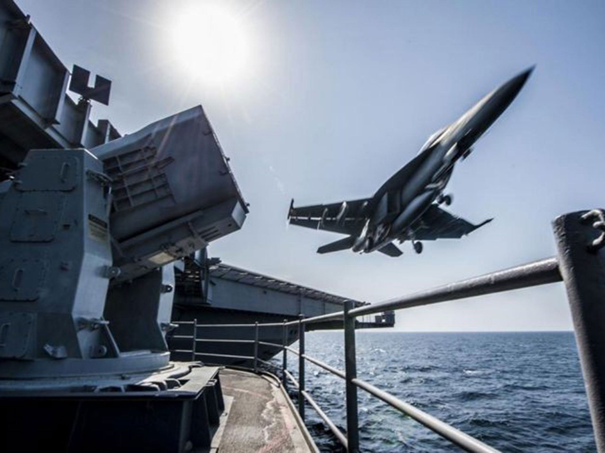A fighter jet takes off from a US war ship