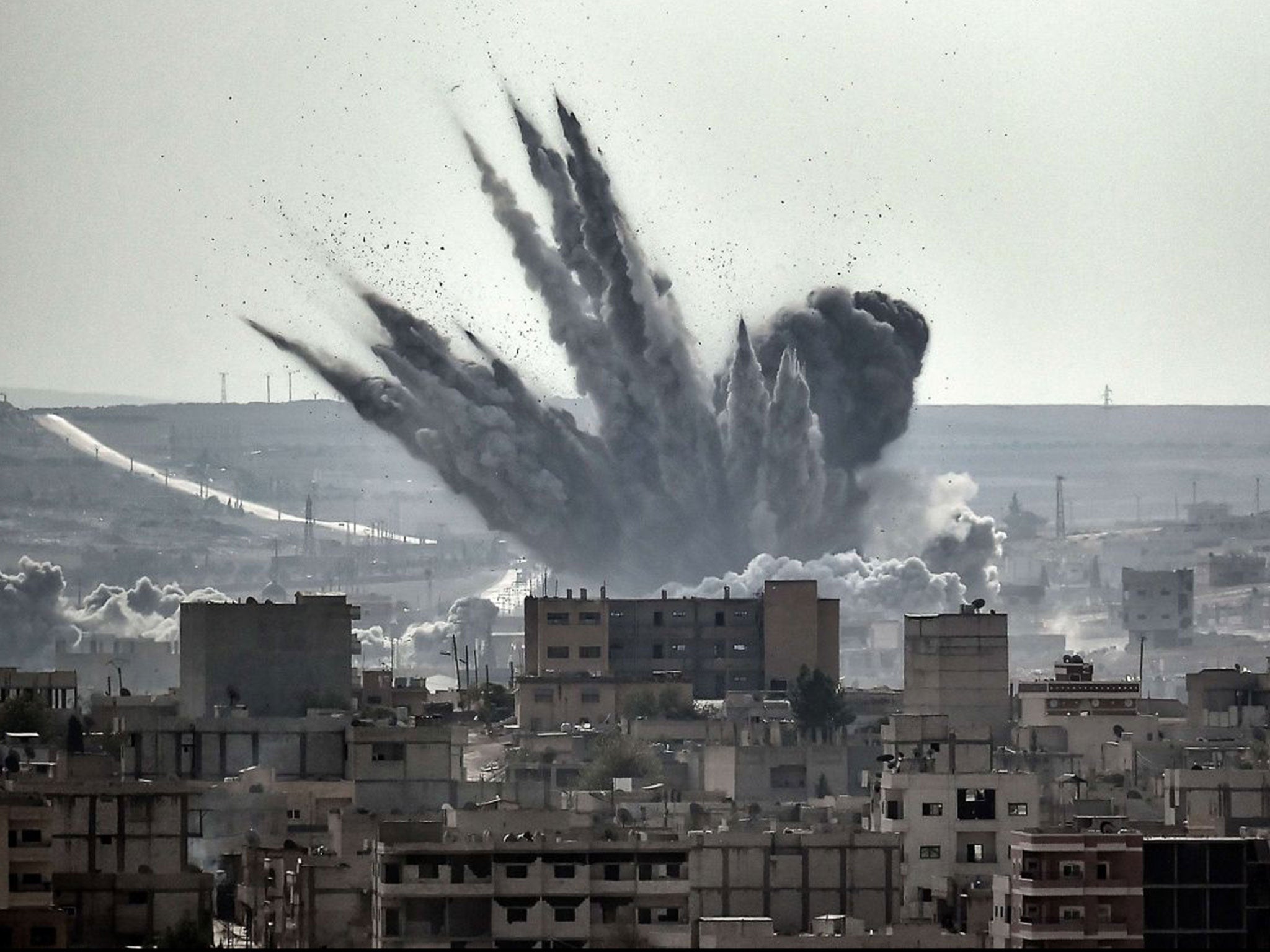 Under attack: A shell explodes in Kobani, Syria