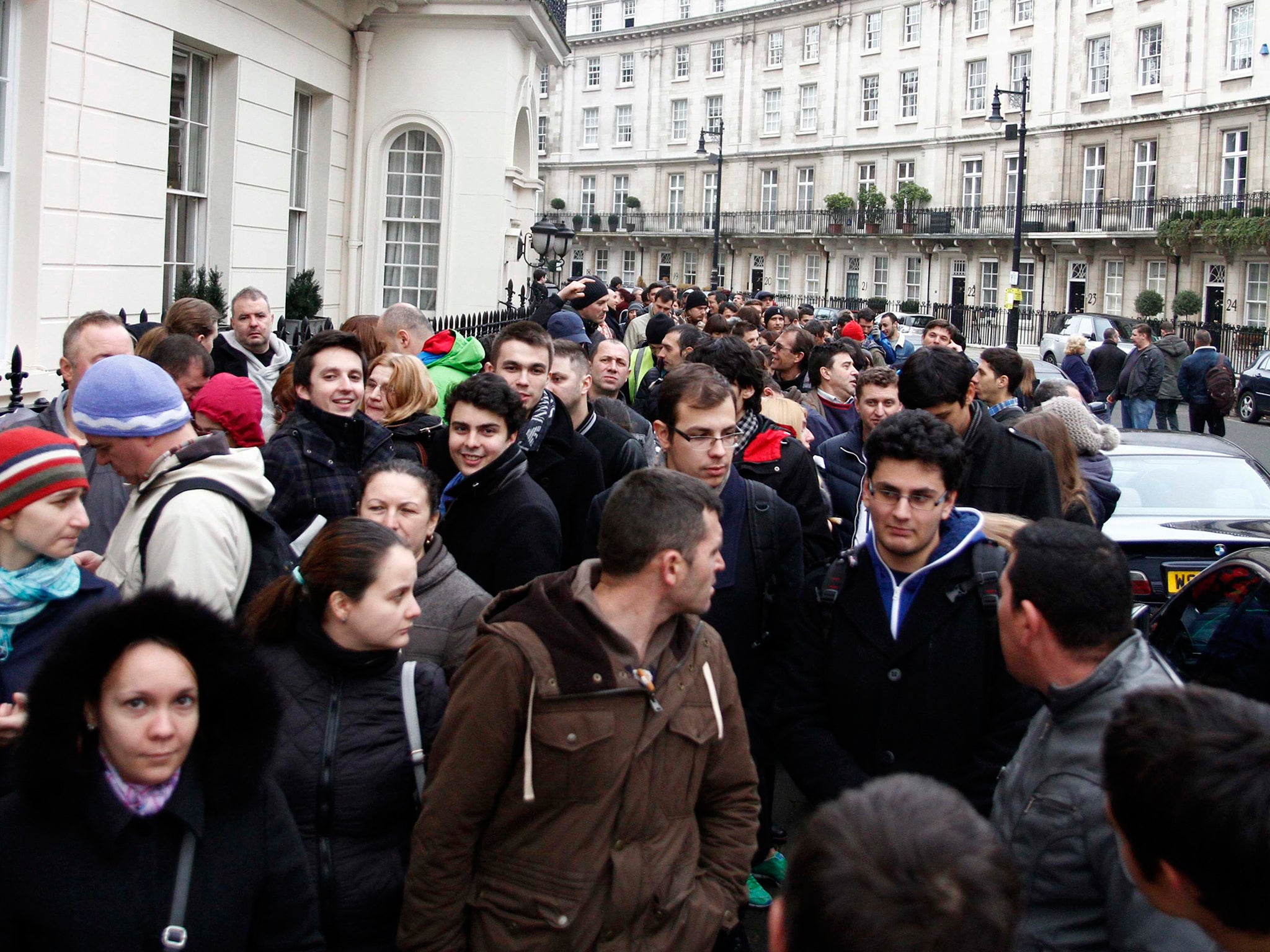 Romanians wait in line to enter a polling station at the Romanian embassy in London