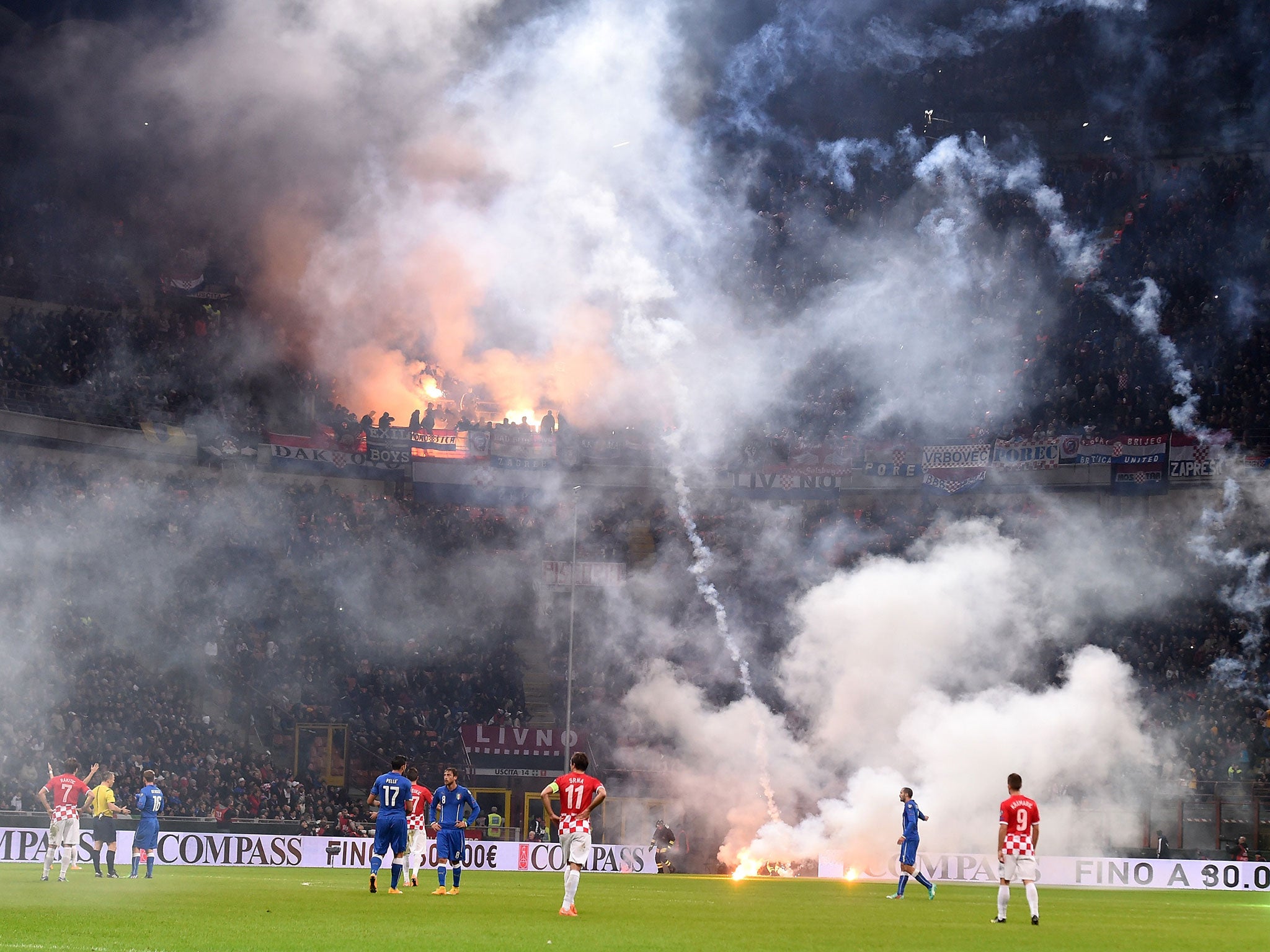 Fans in the away end throw flares onto the pitch as crowd trouble marred the 1-1 draw between Italy and Croatia