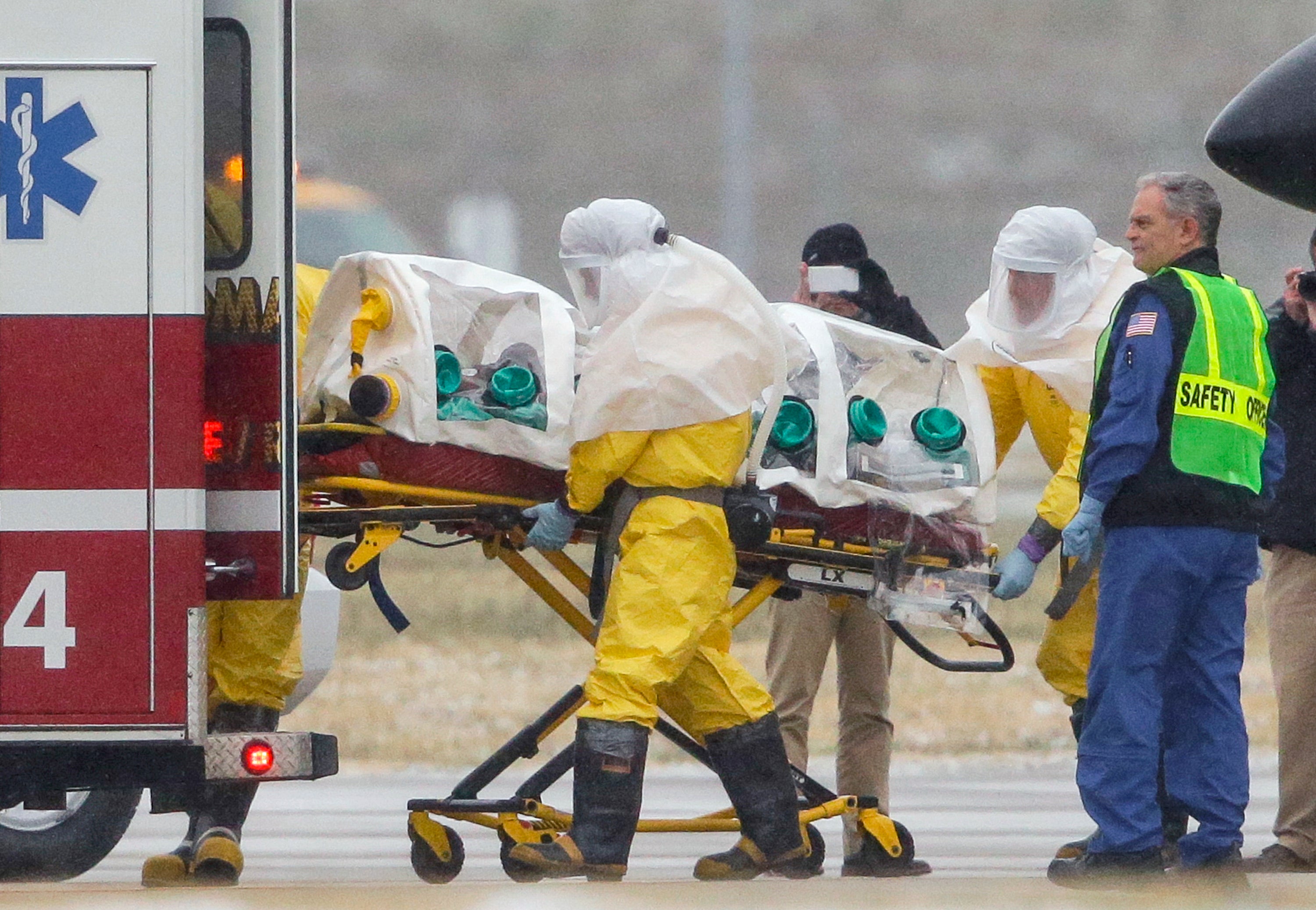 Health workers in protective suits transport Dr. Martin Salia to the Nebraska Medical Center in Omaha.