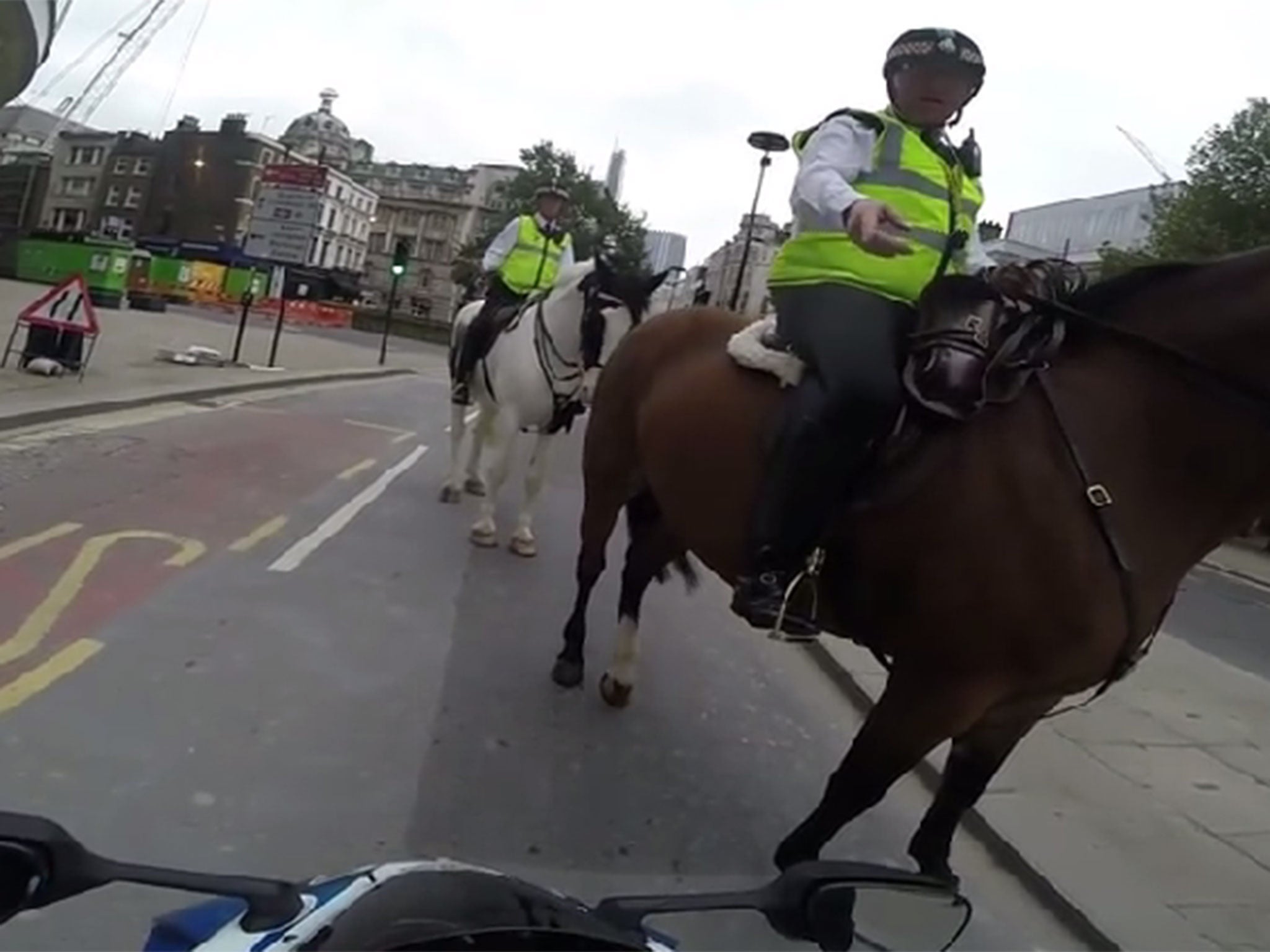 Watch a mounted police officer give a motorcyclist a telling off for pulling a wheelie.