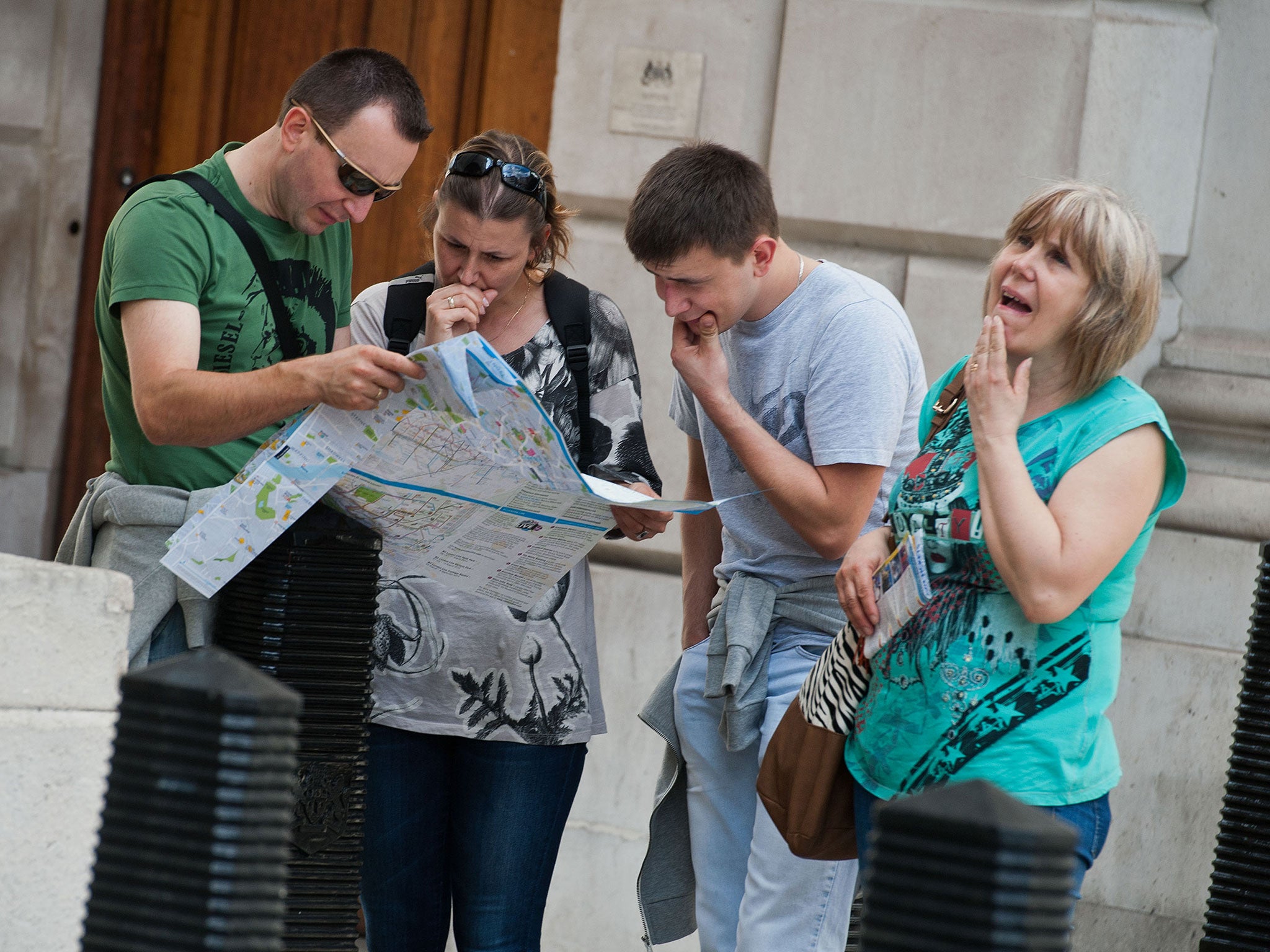Tourists examine a map.