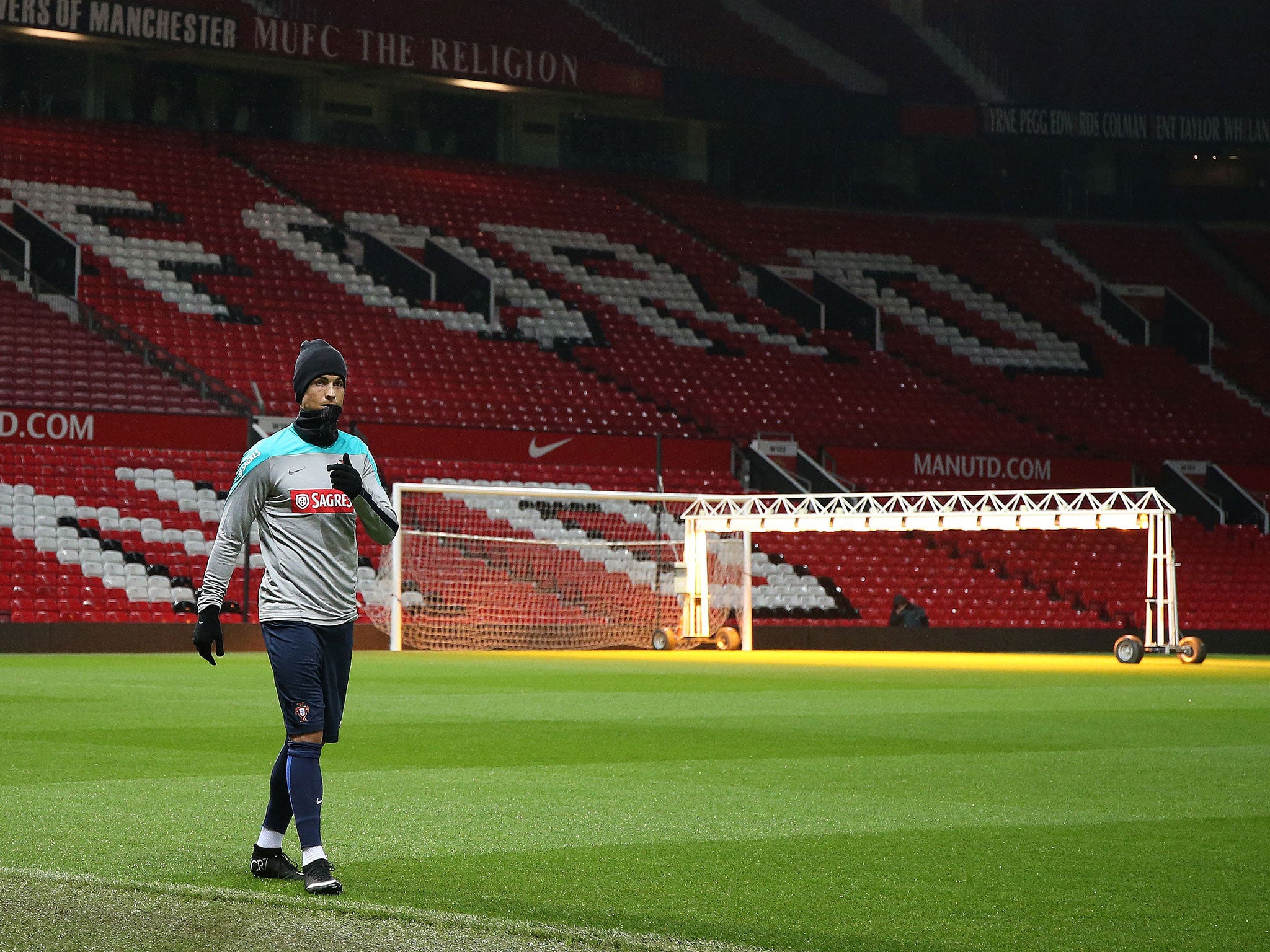 Cristiano Ronaldo trains on the pitch at Old Trafford