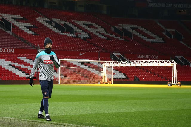 Cristiano Ronaldo trains on the pitch at Old Trafford