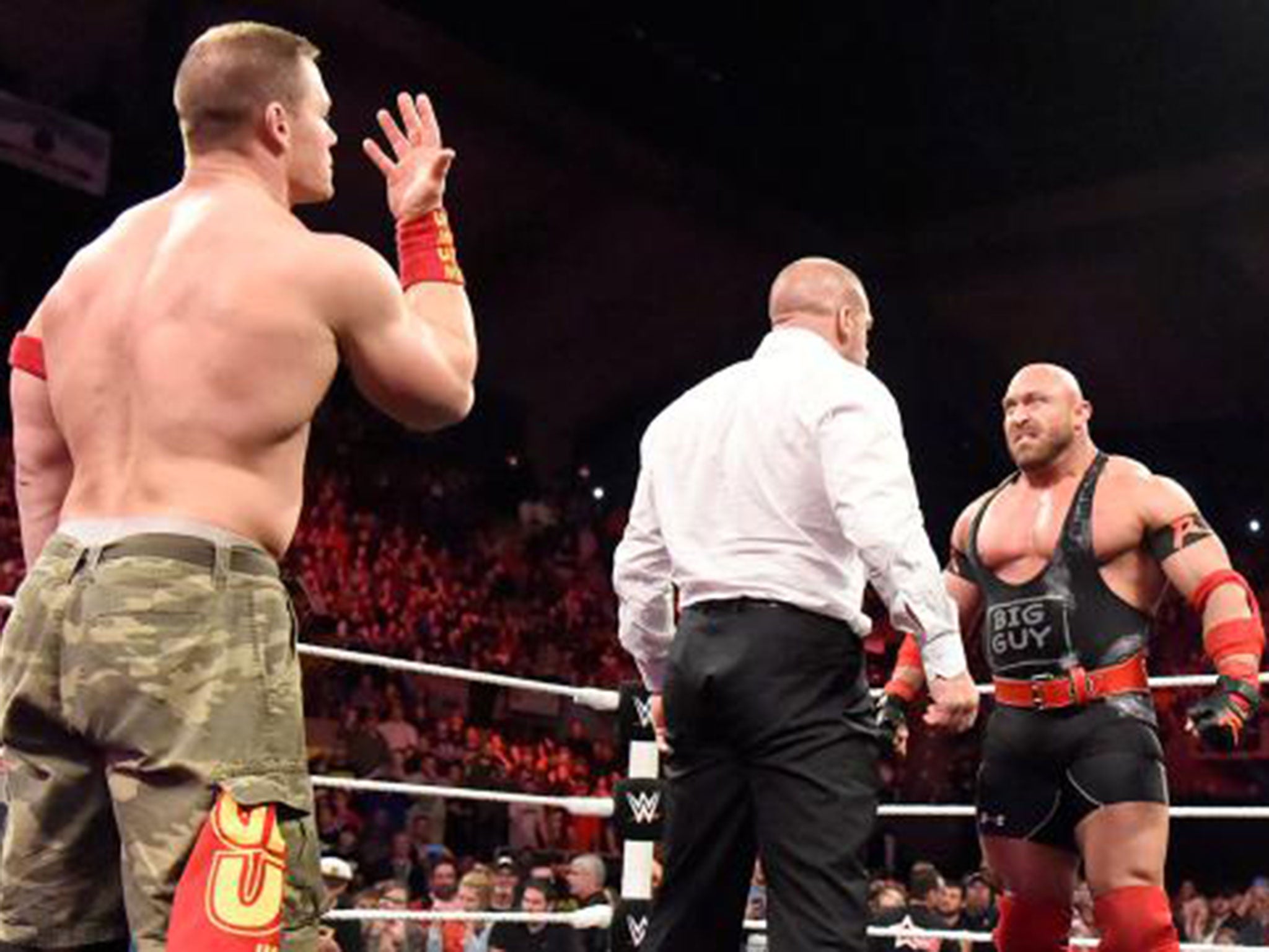 Ryback confronts Triple H as John Cena taunts him from behind