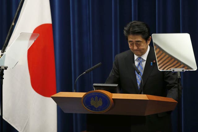 Japan's Prime Minister Shinzo Abe attends a news conference at his official residence in Tokyo November 18, 2014