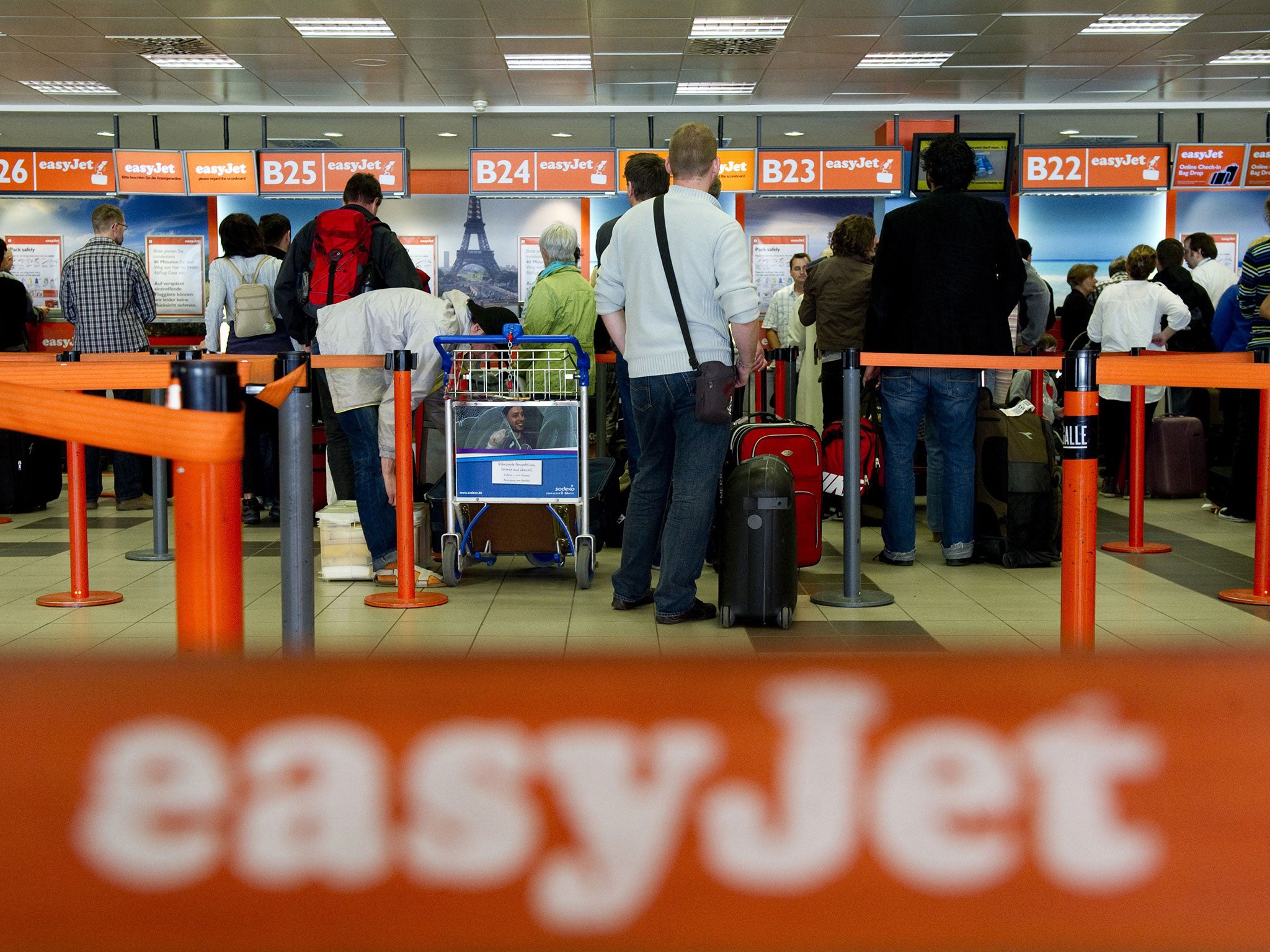Passengers queue up at the Easyjet counter at Berlin's Schoenefeld airport.