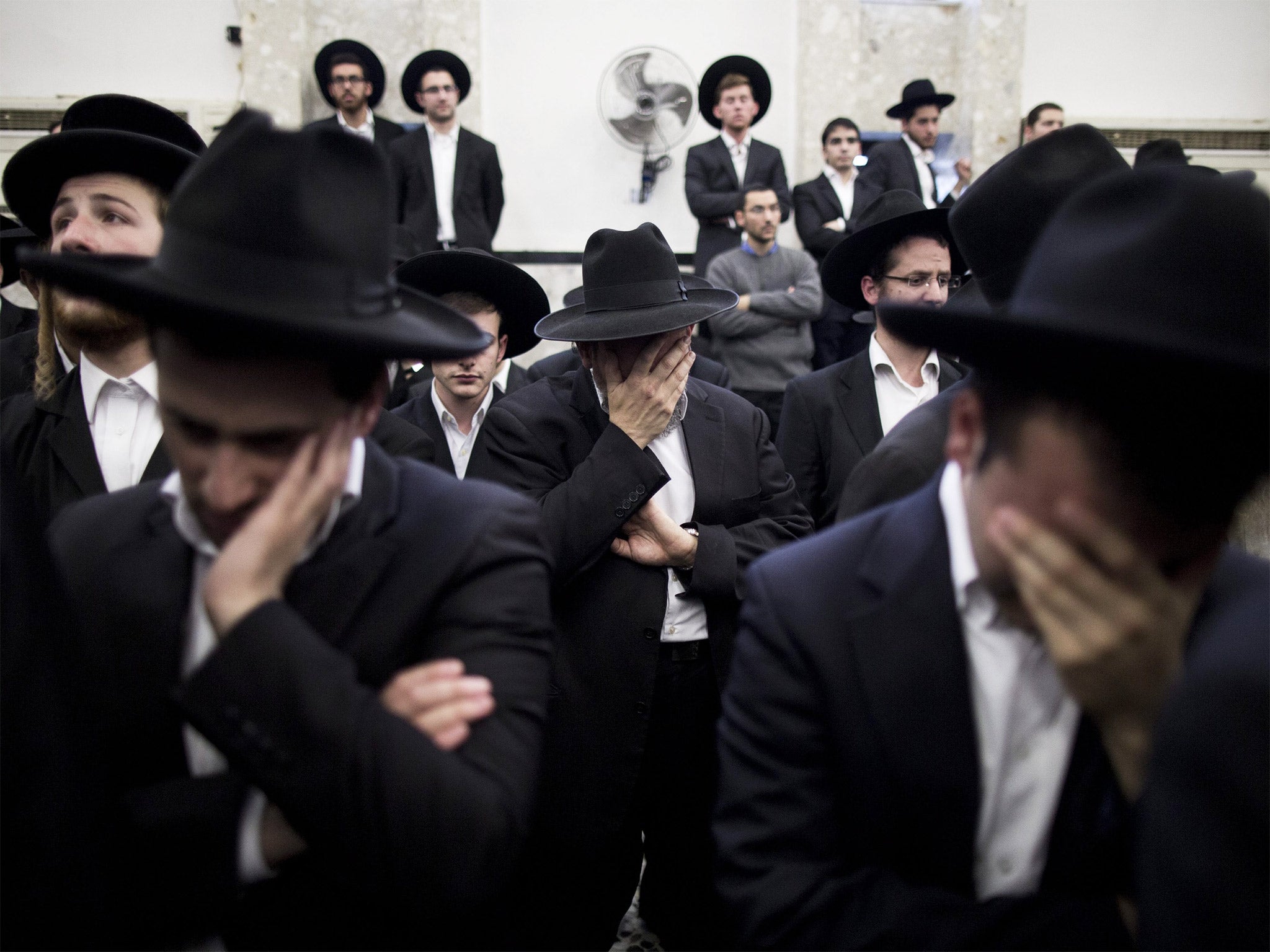 Ultra-Orthodox Jews mourn during a eulogy ceremony ahead of the funeral of Rabbi Moshe Twersky, one of the four jewish victims
