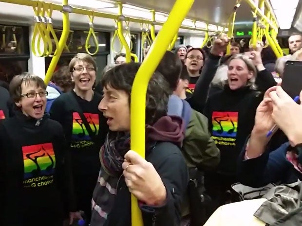 Members of Manchester Gay and Lesbian Chorus sing on a tram in solidarity with two victims of a homophobic attack