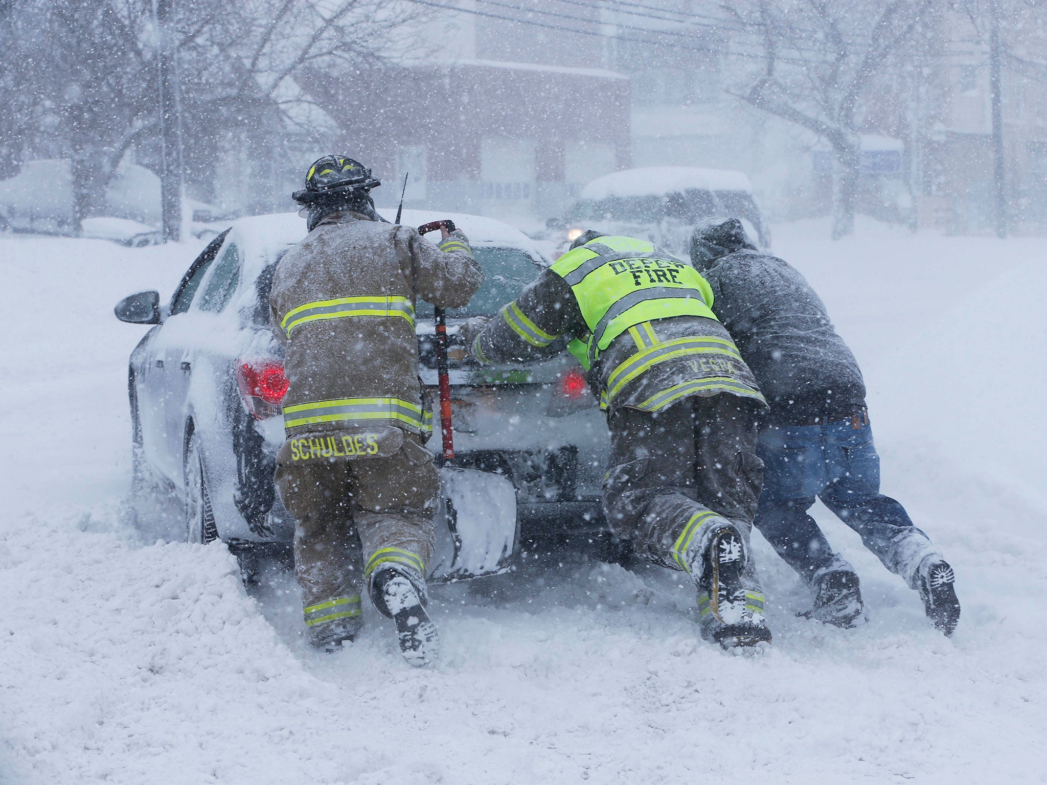 Firefighters from West End Hose Company in Depew, help a stuck motorist on Transit Road