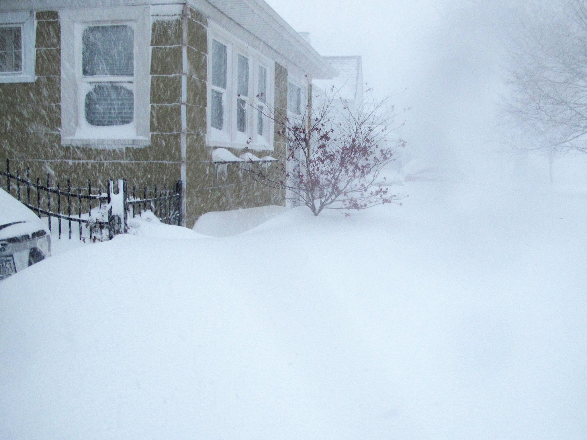 Heavy snow covers a pavement in Buffalo residential area