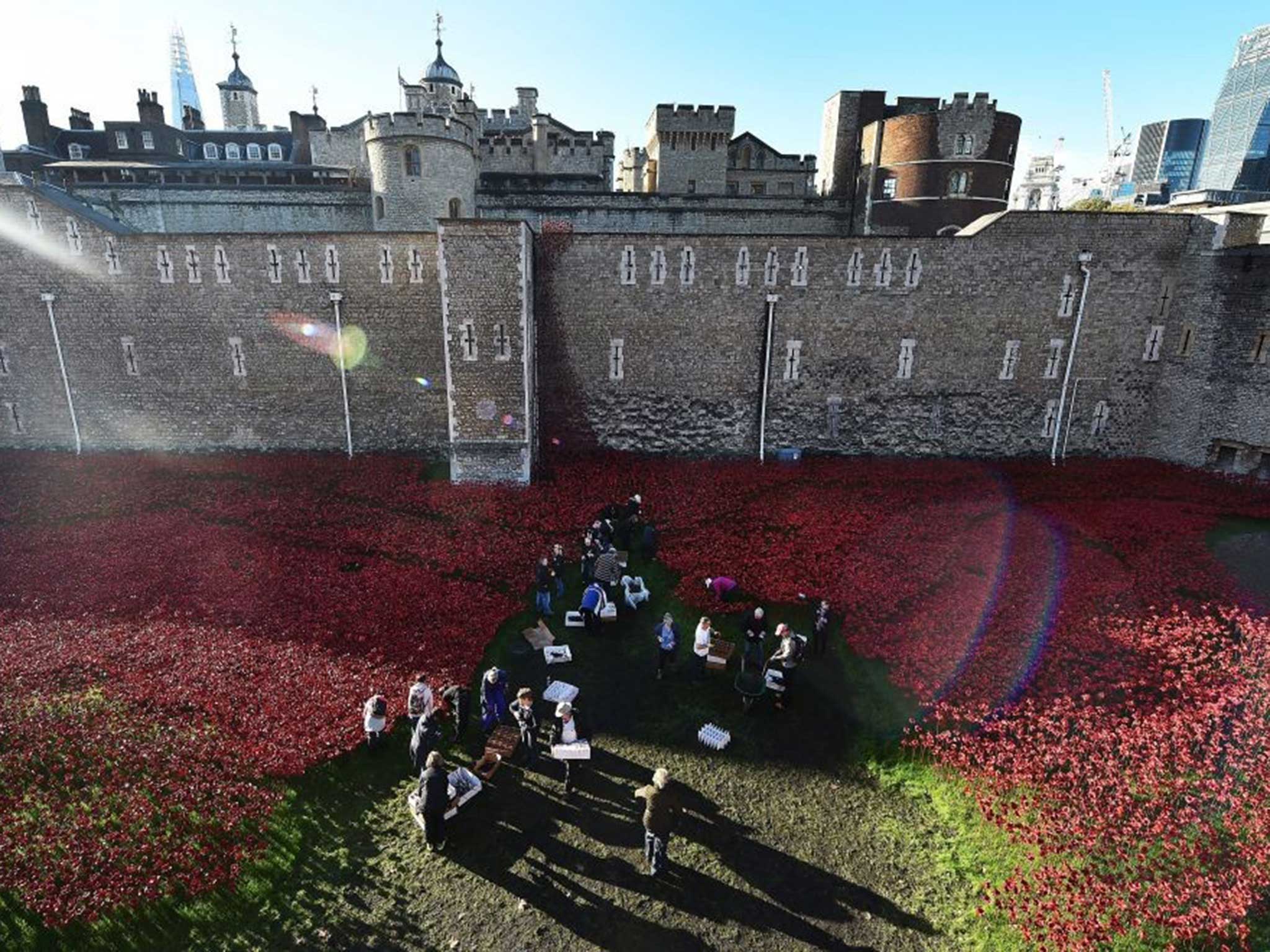 Volunteers start packing away the poppies surrounding the Tower of London