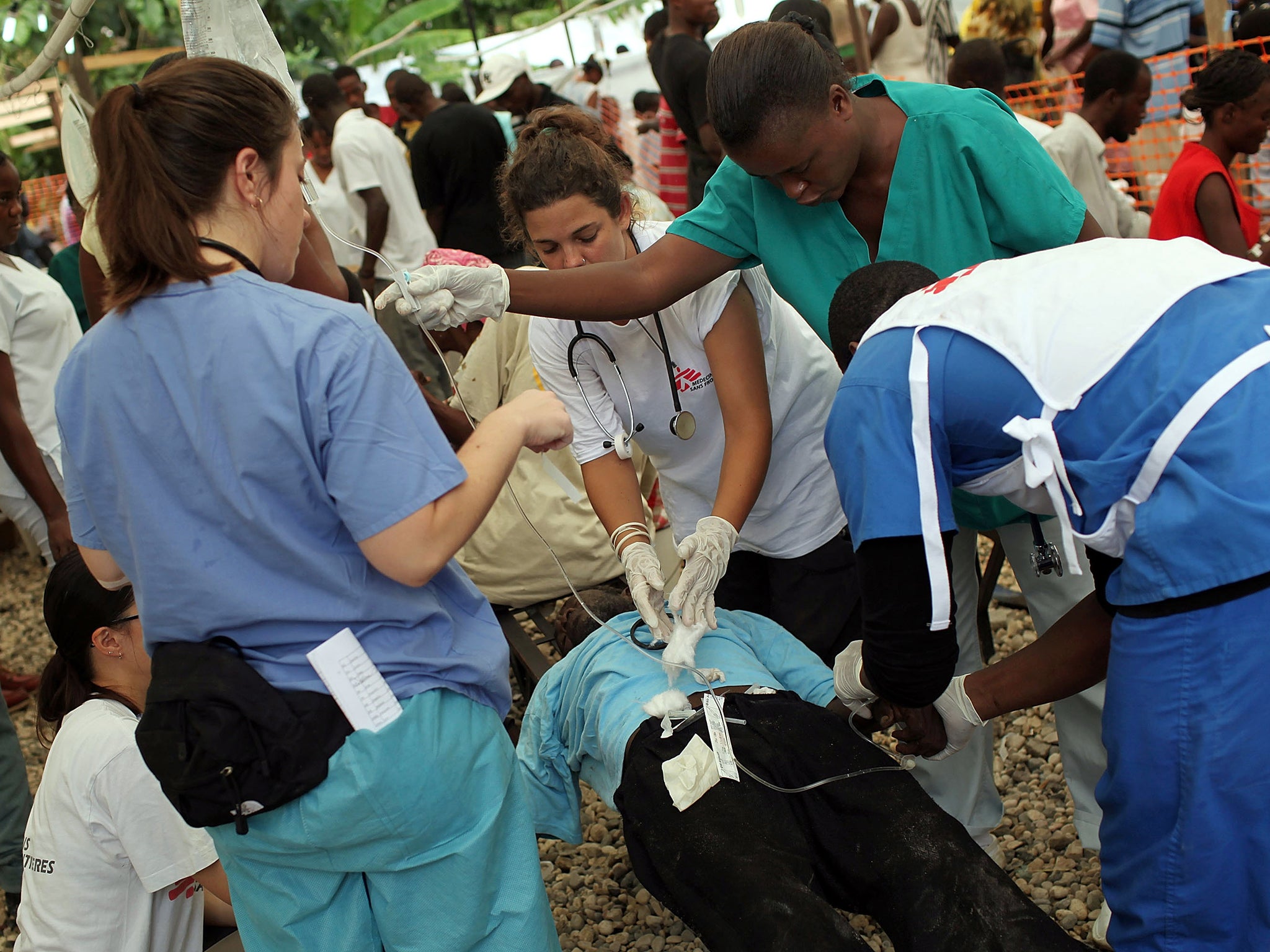 Fight for life: MSF volunteers treat a cholera patient in Haiti in 2010 after an earthquake made a million homeless and disease spread