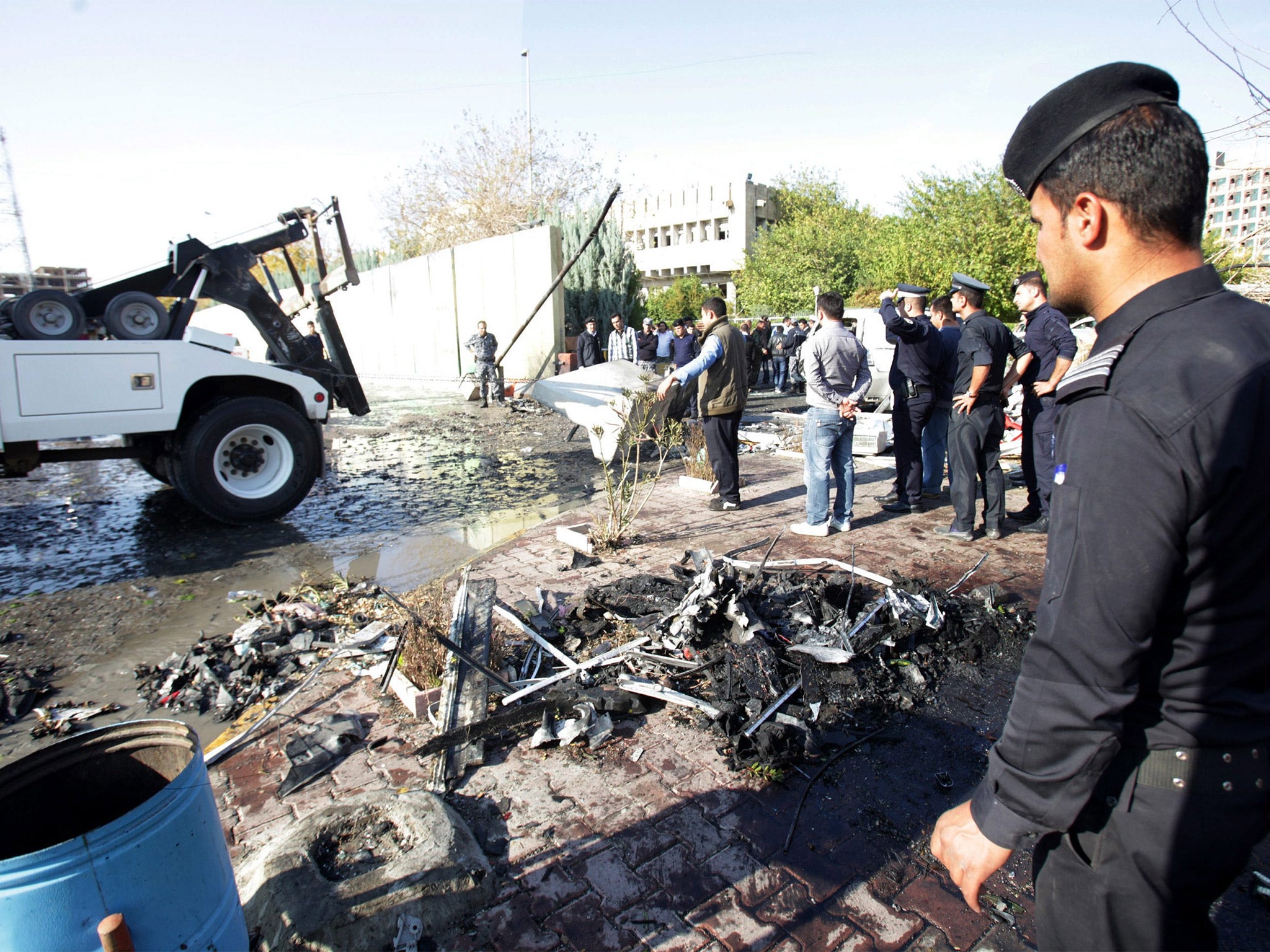 Kurdish police at the site of a suicide bomb attack in Erbil