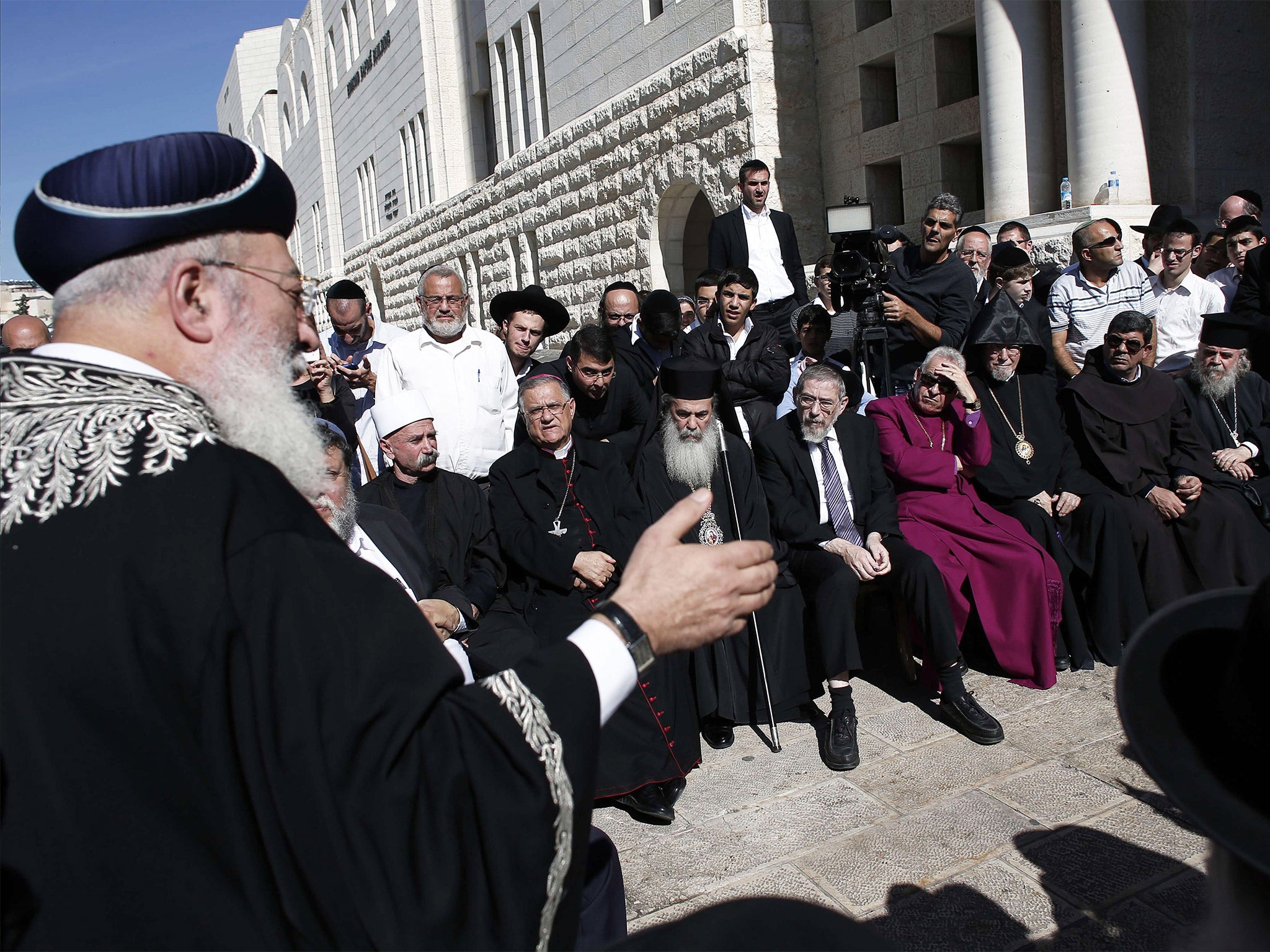 Sephardi Chief Rabbi of Israel Shlomo Amar (left) gives a speech at the synagogue following Tuesday’s attack (Getty)