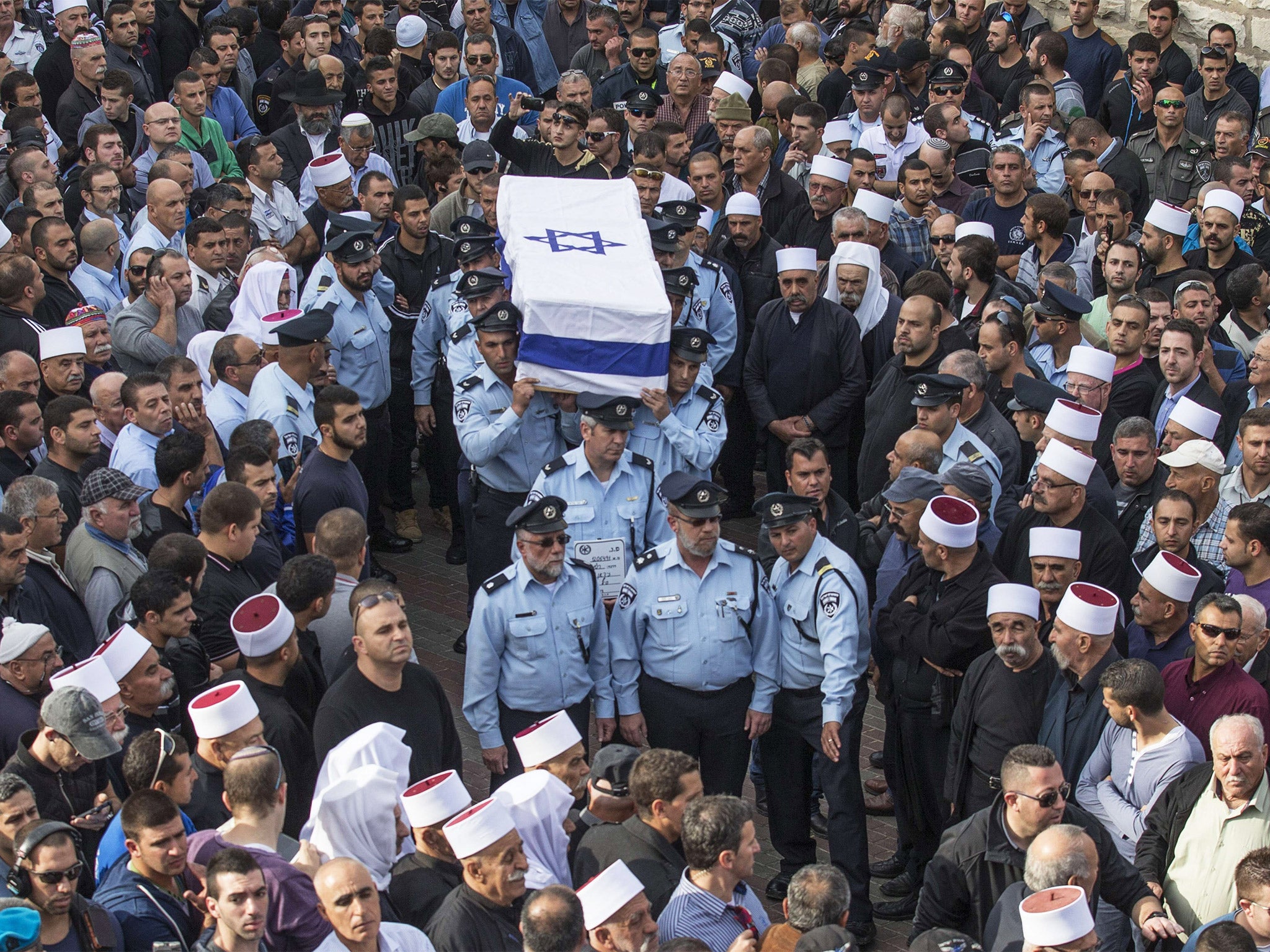 Israeli police officers carry the coffin of their comrade Zidan Saief during his funeral in his home village of Yanuh-Jat (Getty)