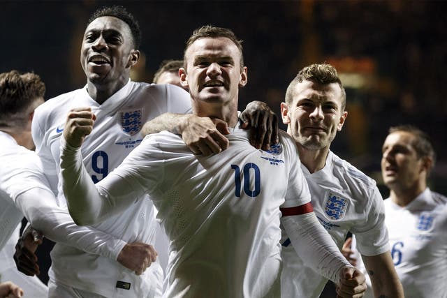 Wayne Rooney (centre) celebrates his first goal against Scotland