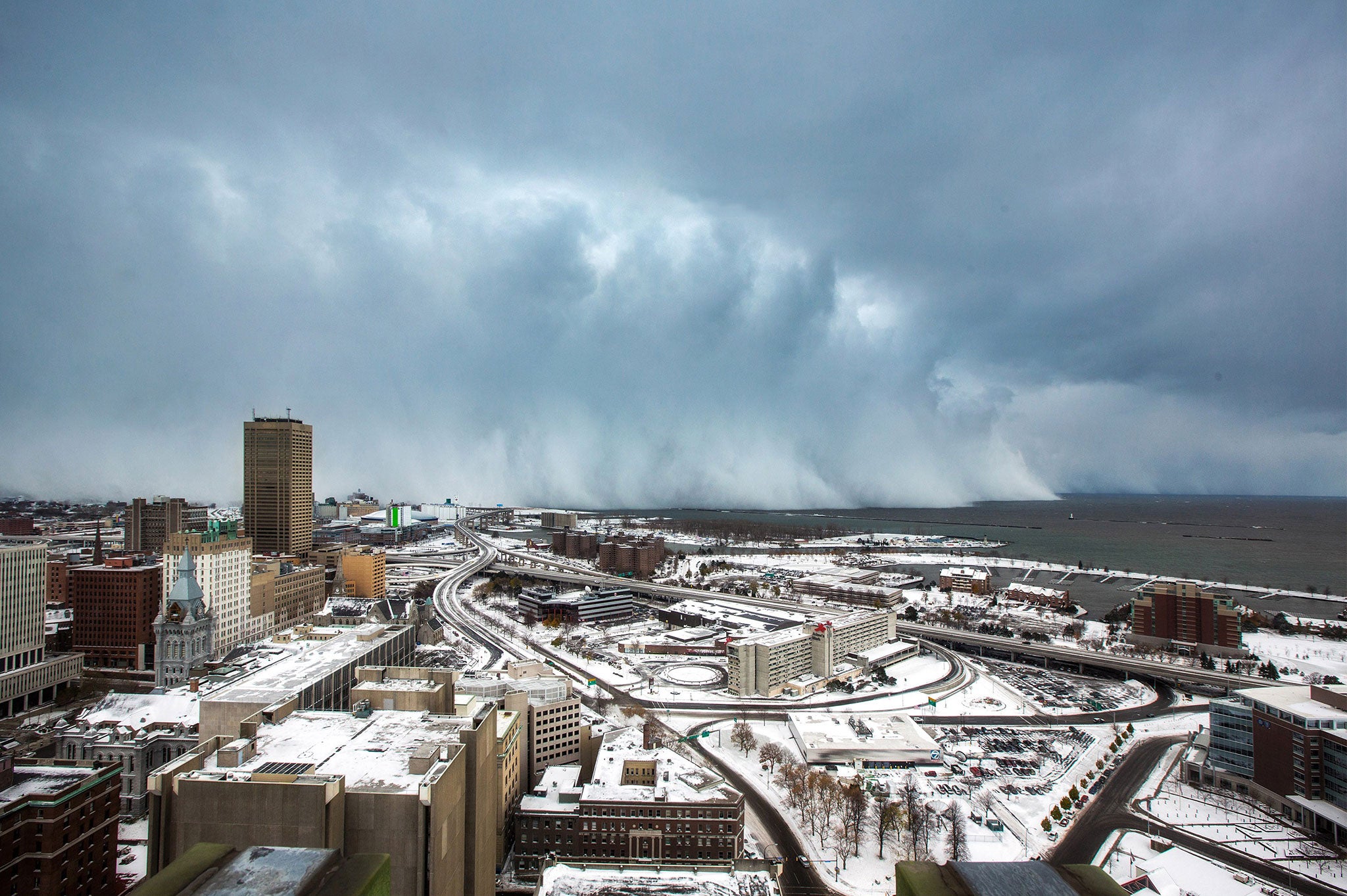 Storm clouds and snow blows off Lake Erie in Buffalo, New York, November 18, 2014
