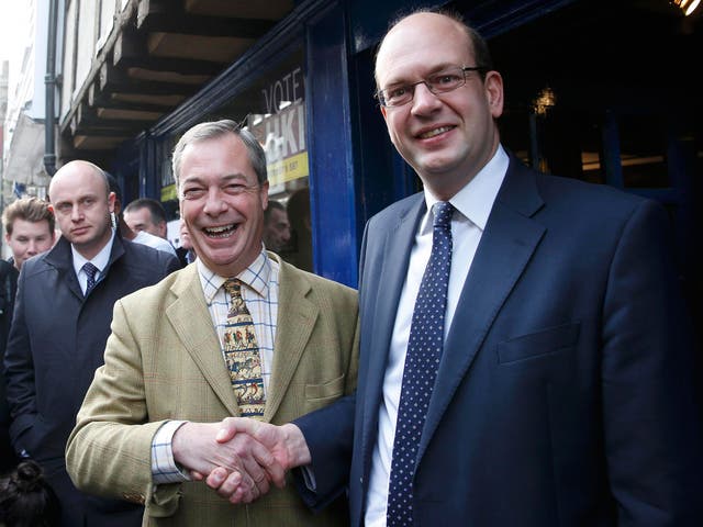 Nigel Farage shakes hands with Mark Reckless, the former Conservative Party member of Parliament for Rochester and Strood, on polling day 