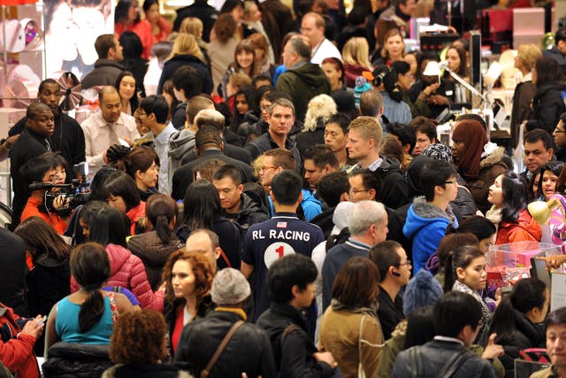 People crowd the first floor of Macy's department store as they open at midnight (0500 GMT) on November 23, 2012 in New York to start the stores' 'Black Friday' shopping weekend.
