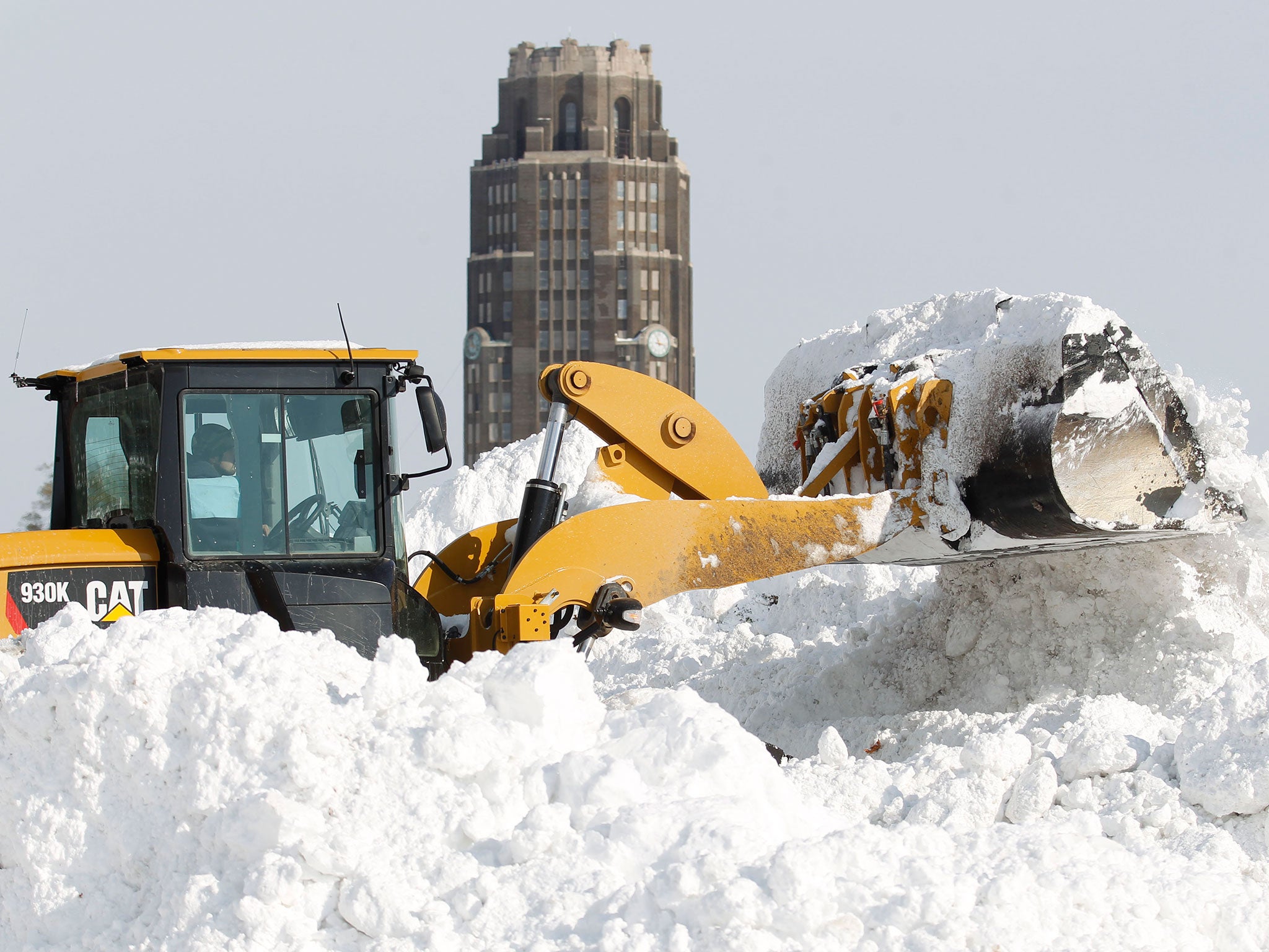 A frontend loader piles snow after dump trucks dropped loads of snow at the Central Terminal in Buffalo