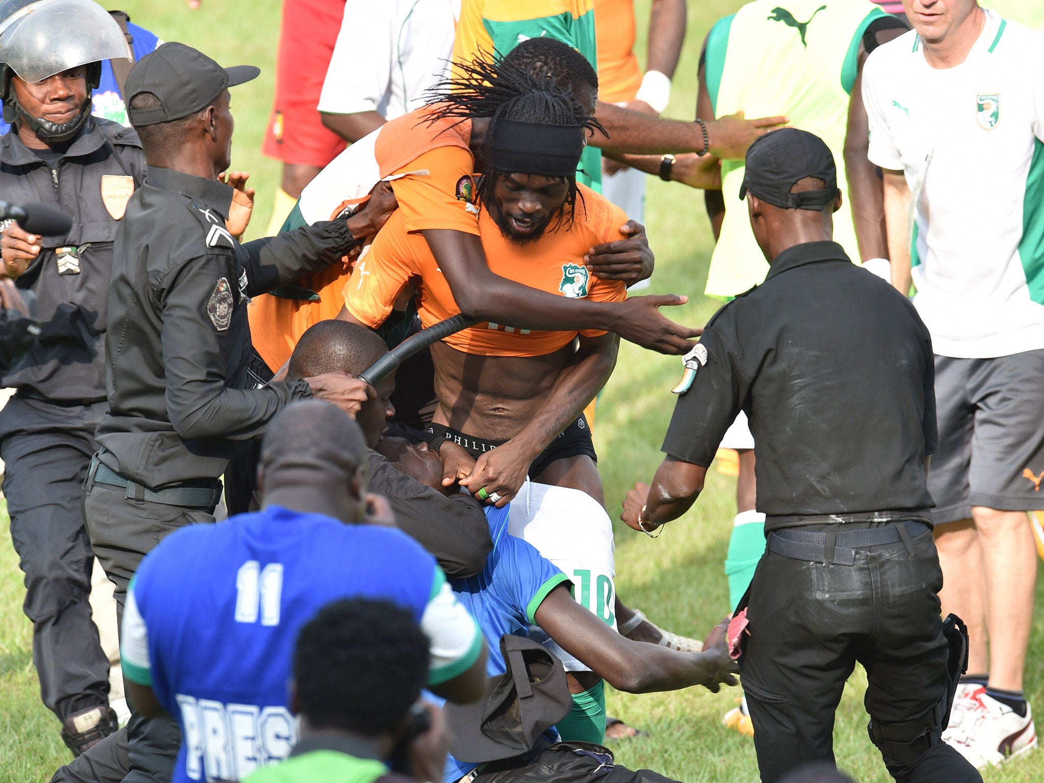 Gervinho is mobbed by rioters after Ivory Coast's 0-0 draw with Cameroon