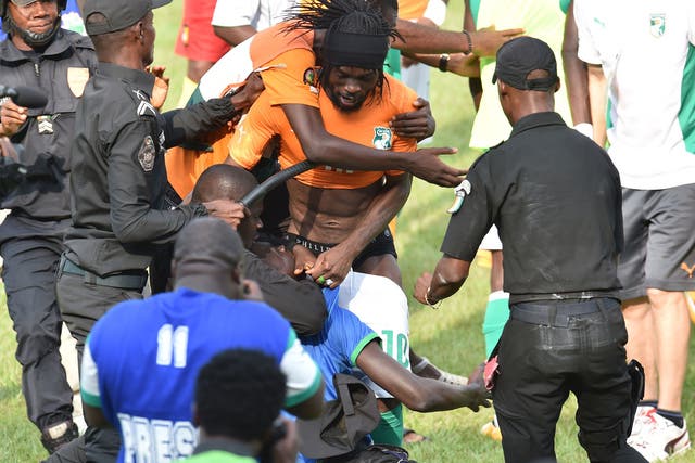 Gervinho is mobbed by rioters after Ivory Coast's 0-0 draw with Cameroon