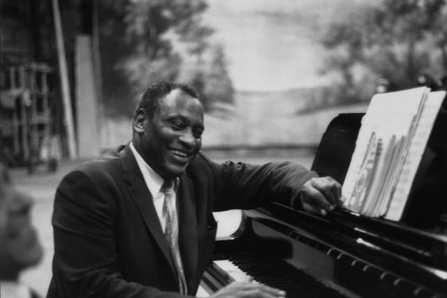 American singer, acclaimed actor of stage and screen, political activist and civil rights campaigner Paul Robeson (1898 - 1976), rehearses in relaxed mood at the piano.  