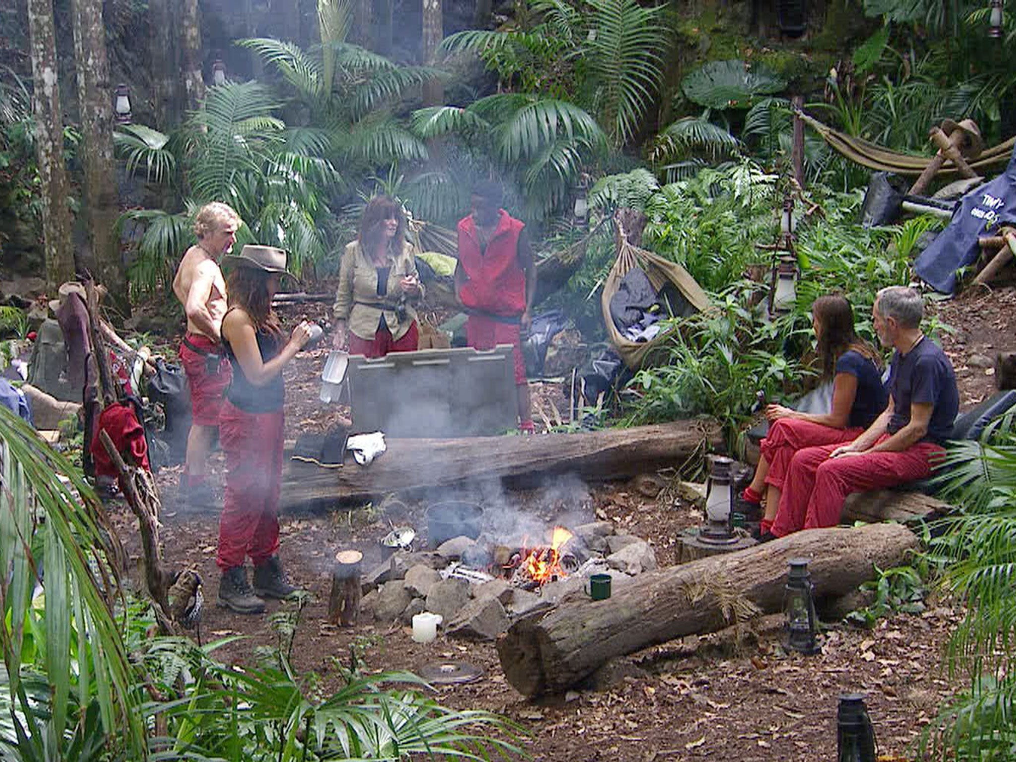 Contestants around the campfire