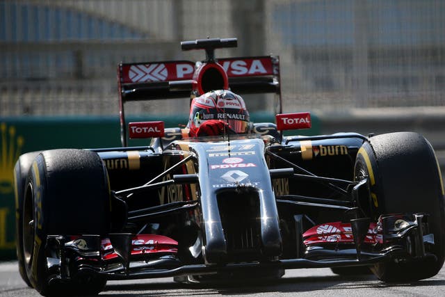 Romain Grosjean turns in as his Lotus glistens in the Abu Dhabi sun