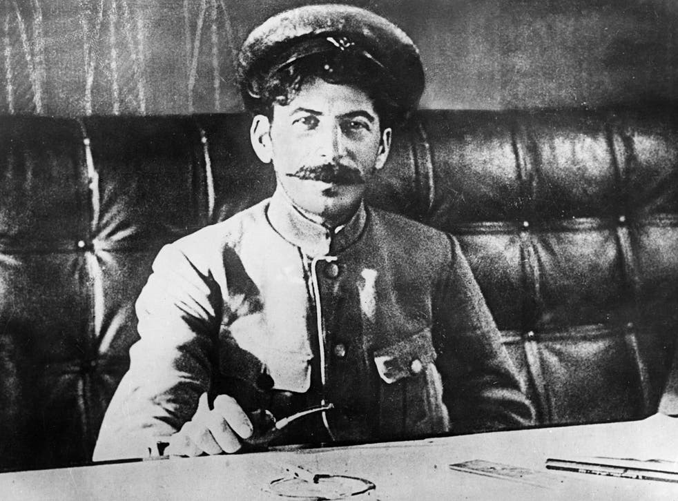 Joseph Stalin sitting at a table in 1918