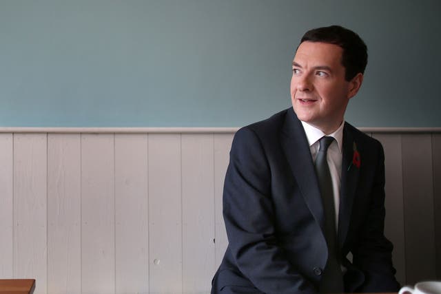 British Chancellor of the Exchequer George Osborne visits the Relish cafe to meet with local people (unseen) on October 24, 2014 in Beeston, England.