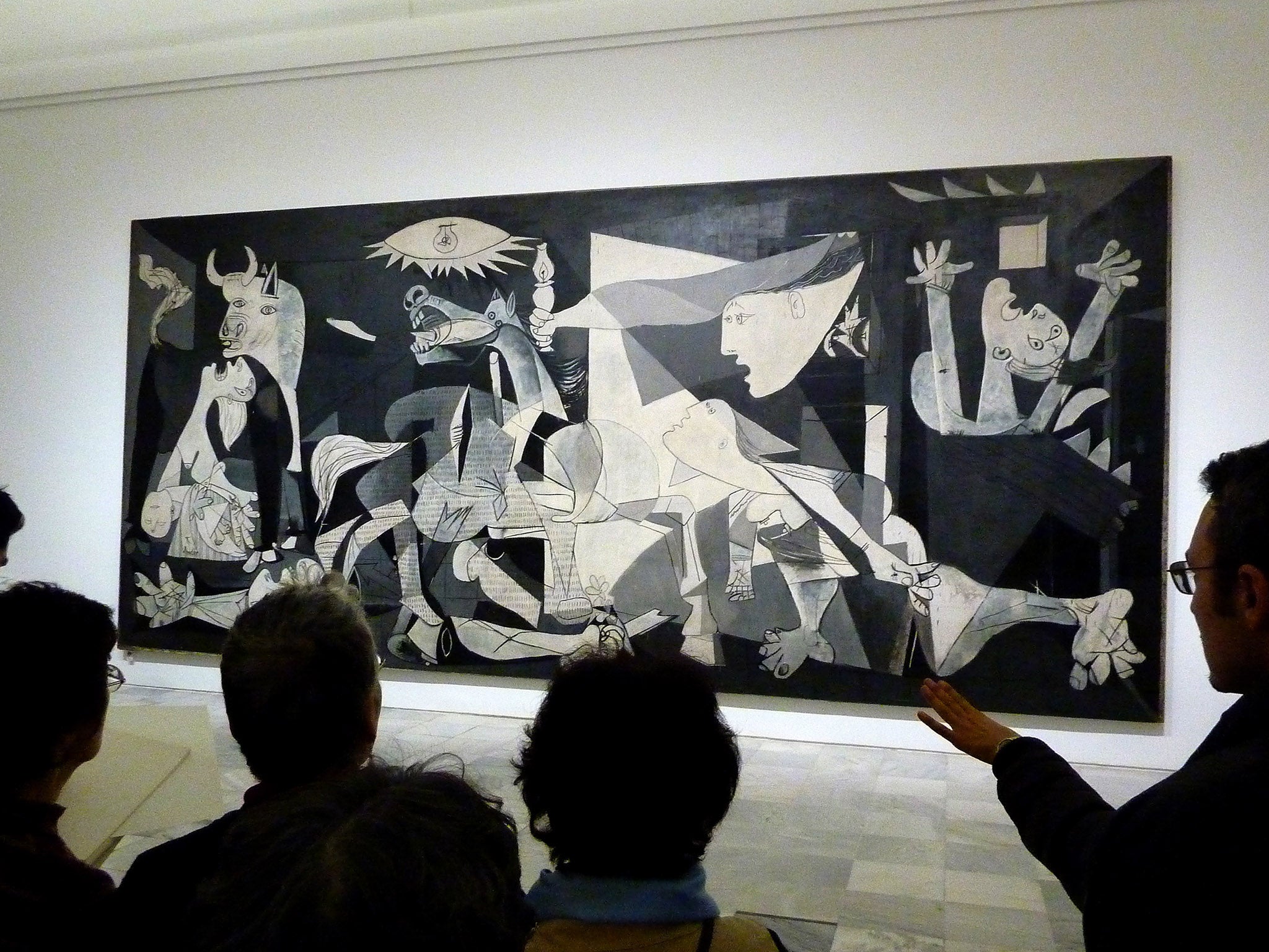 People look at the Guernica painting by Pablo Picasso at the Reina Sofia museum in Madrid on November 16, 2011.