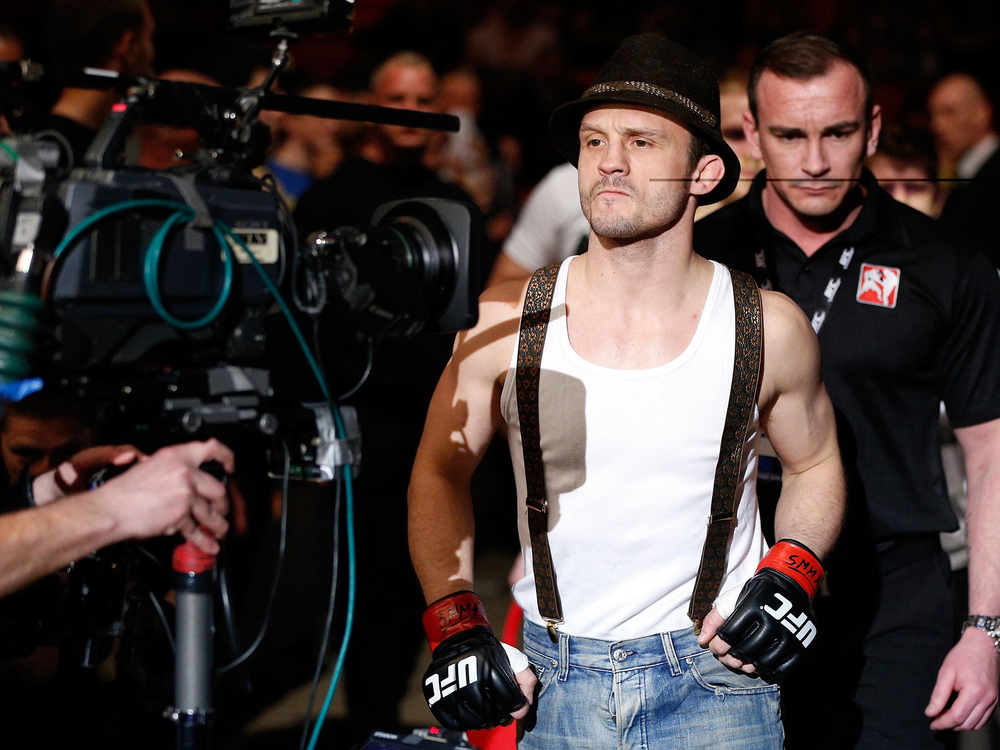 Brad Pickett enters the arena in trademark trilby and vest