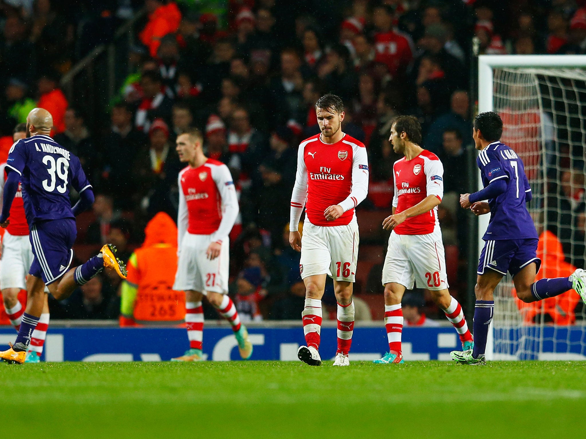 Arsenal players react after Anderlecht scored their third goal in the 3-3 draw